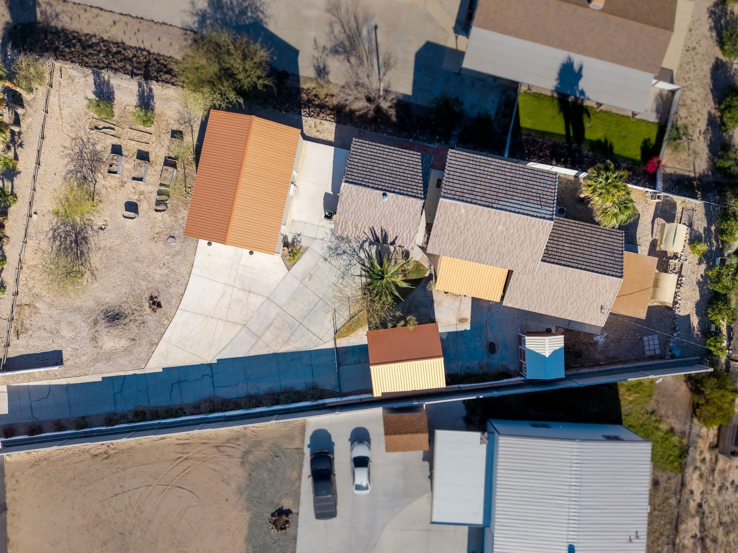Aerial drone view of residential neighborhood streets and houses on a sunny day.