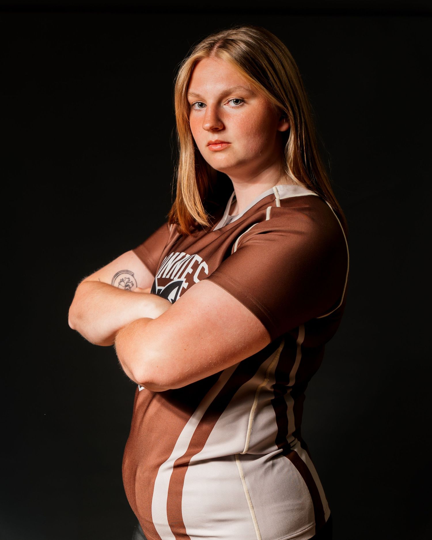 Katie Paterson, a Bonnies Rugby player in a brown and white jersey on media day.