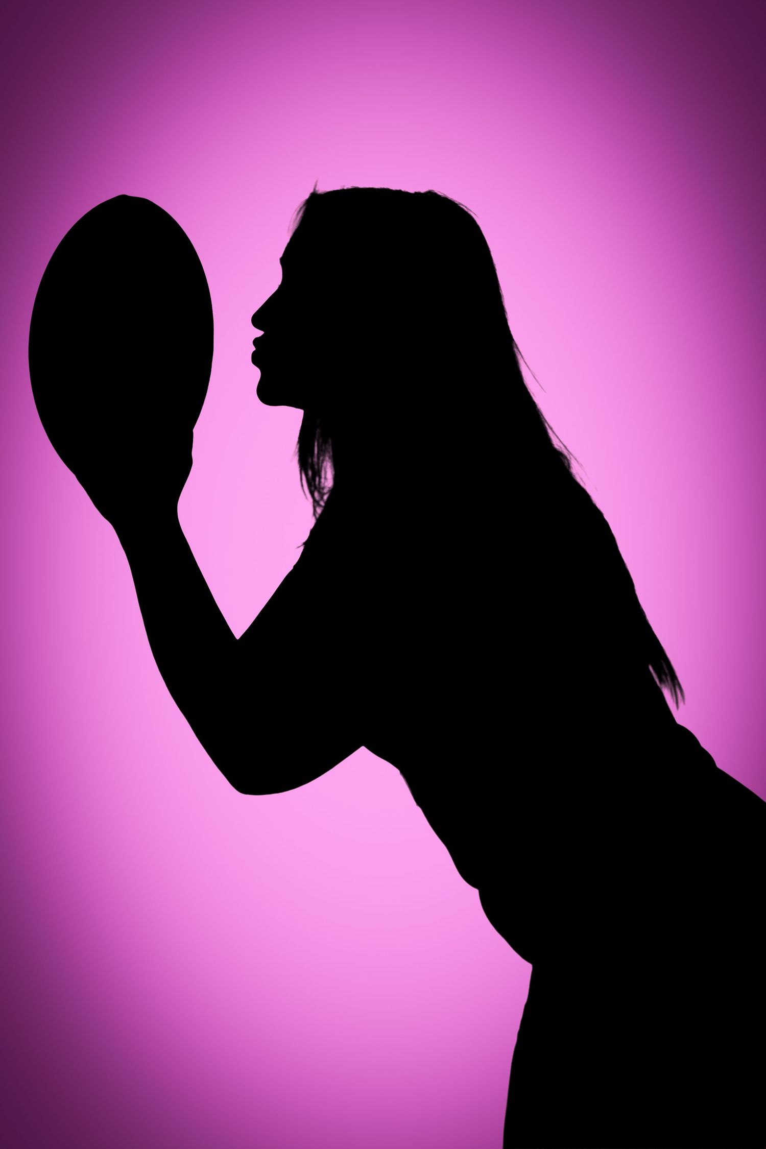 Silhouette of a long-haired person leaning in to kiss a rugby ball against a soft purple gradient background.