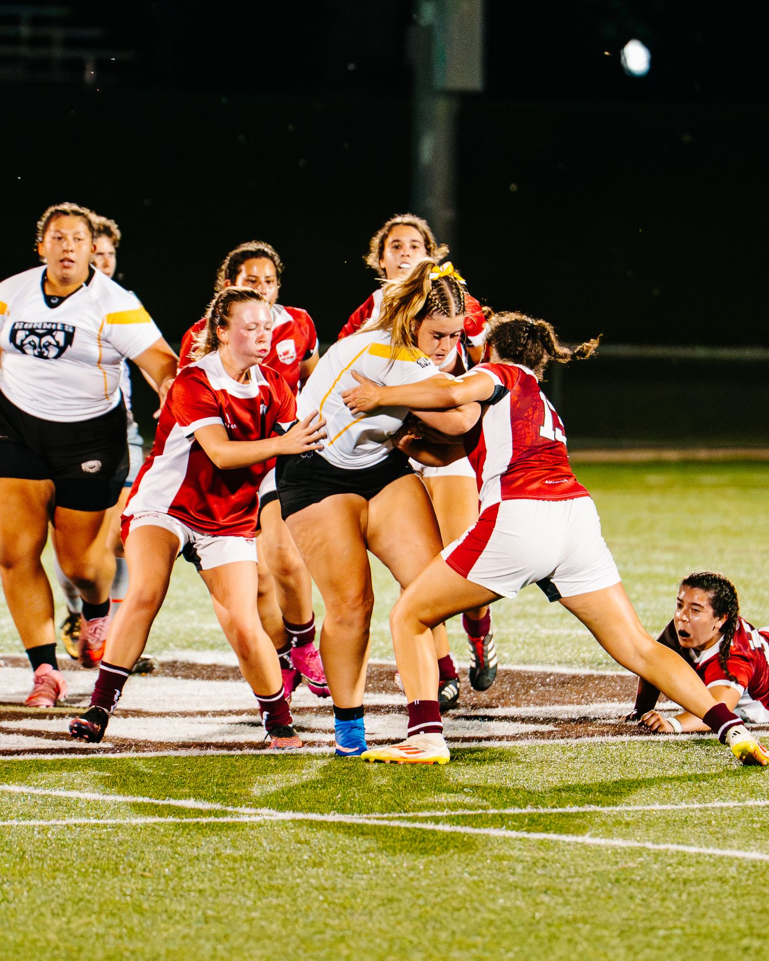 A Bonnies Women's Rugby player, Lexi Thompson, powers through Colgate University's defense.