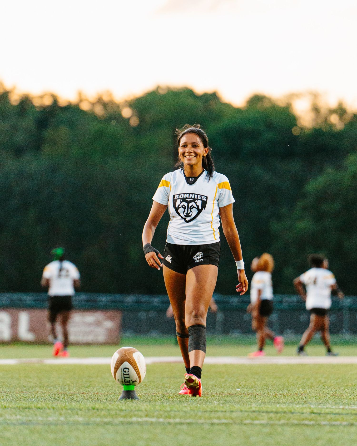 Bonnies Women's Rugby player, Jaden Lockhart, with a big smile getting ready to kick a conversion.