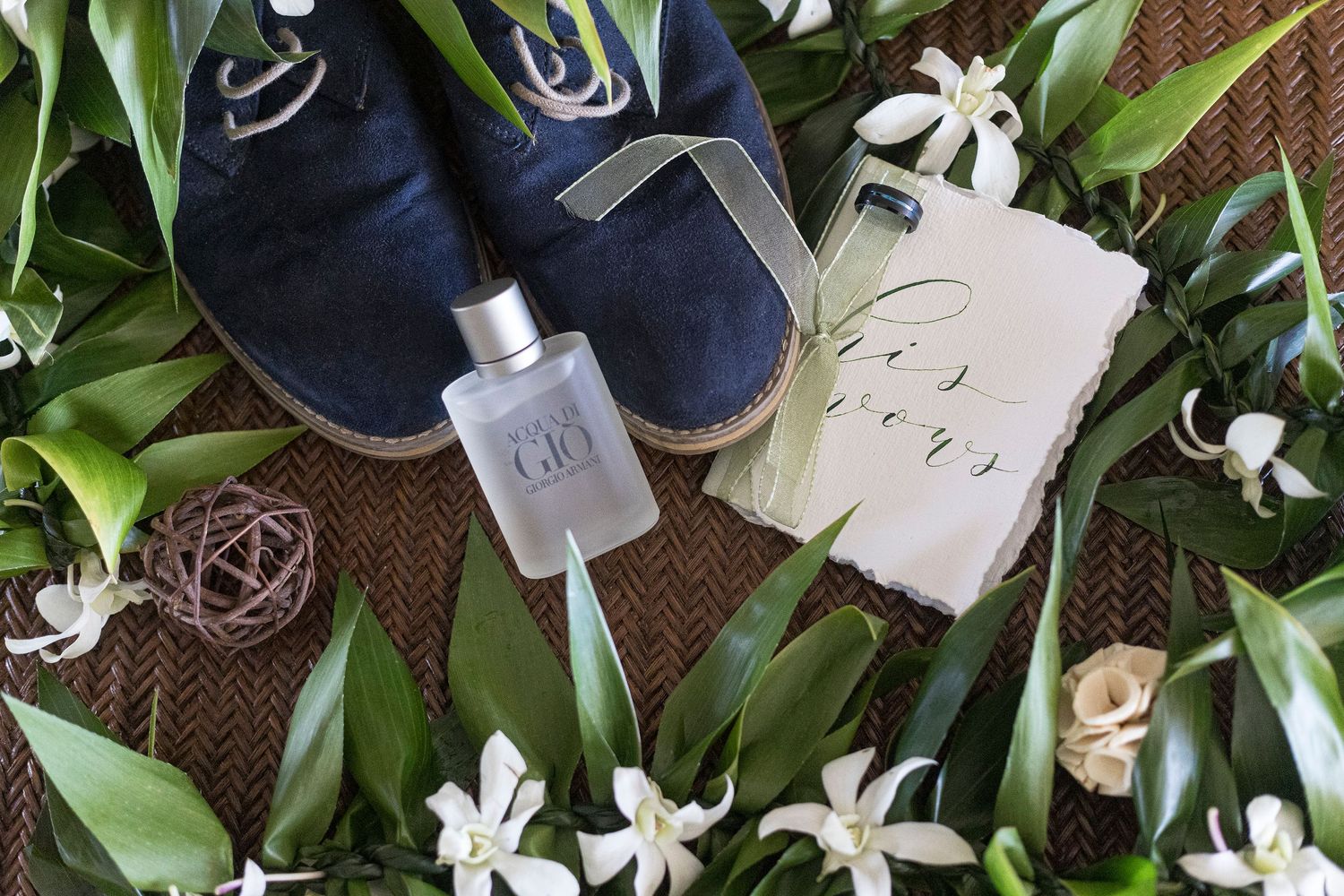 Maui Hawaii Wedding Groom Details Photo with his navy blue ring, cream-colored vow book, lei, and his blue suede shoes