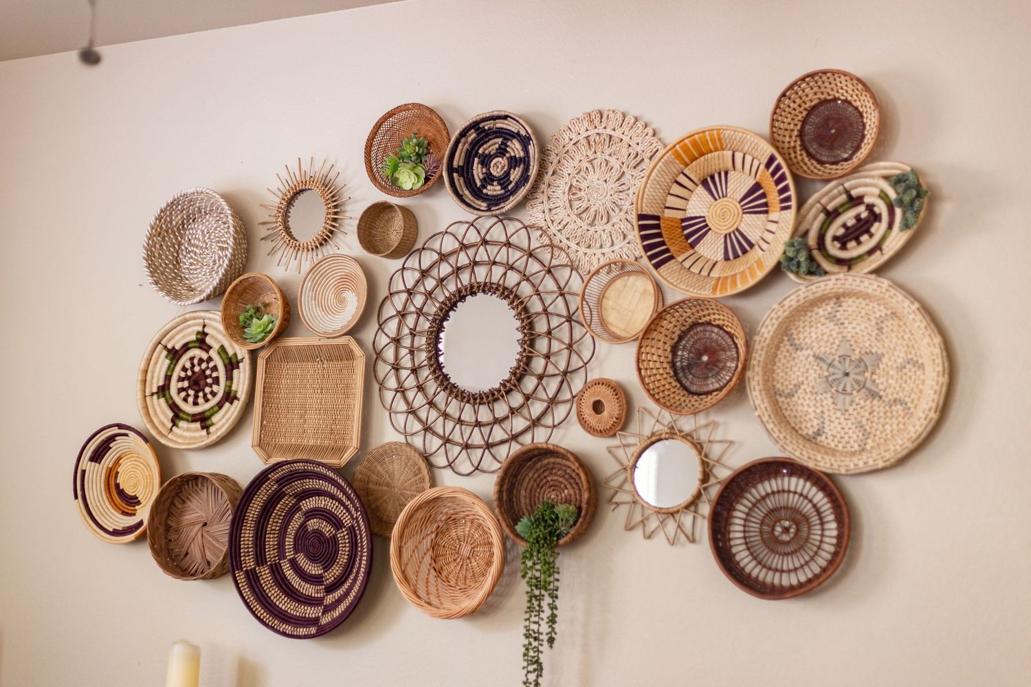 Artistic wall display featuring circular wood slices arranged in a flowing pattern with natural and painted designs.