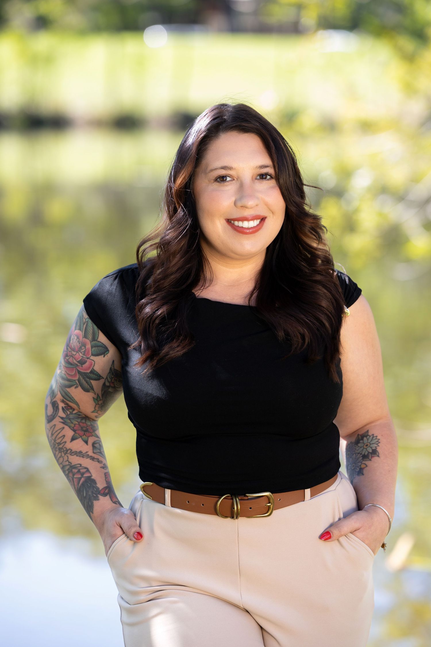 Outdoor portrait session featuring casual black top and beige skirt with natural lighting.