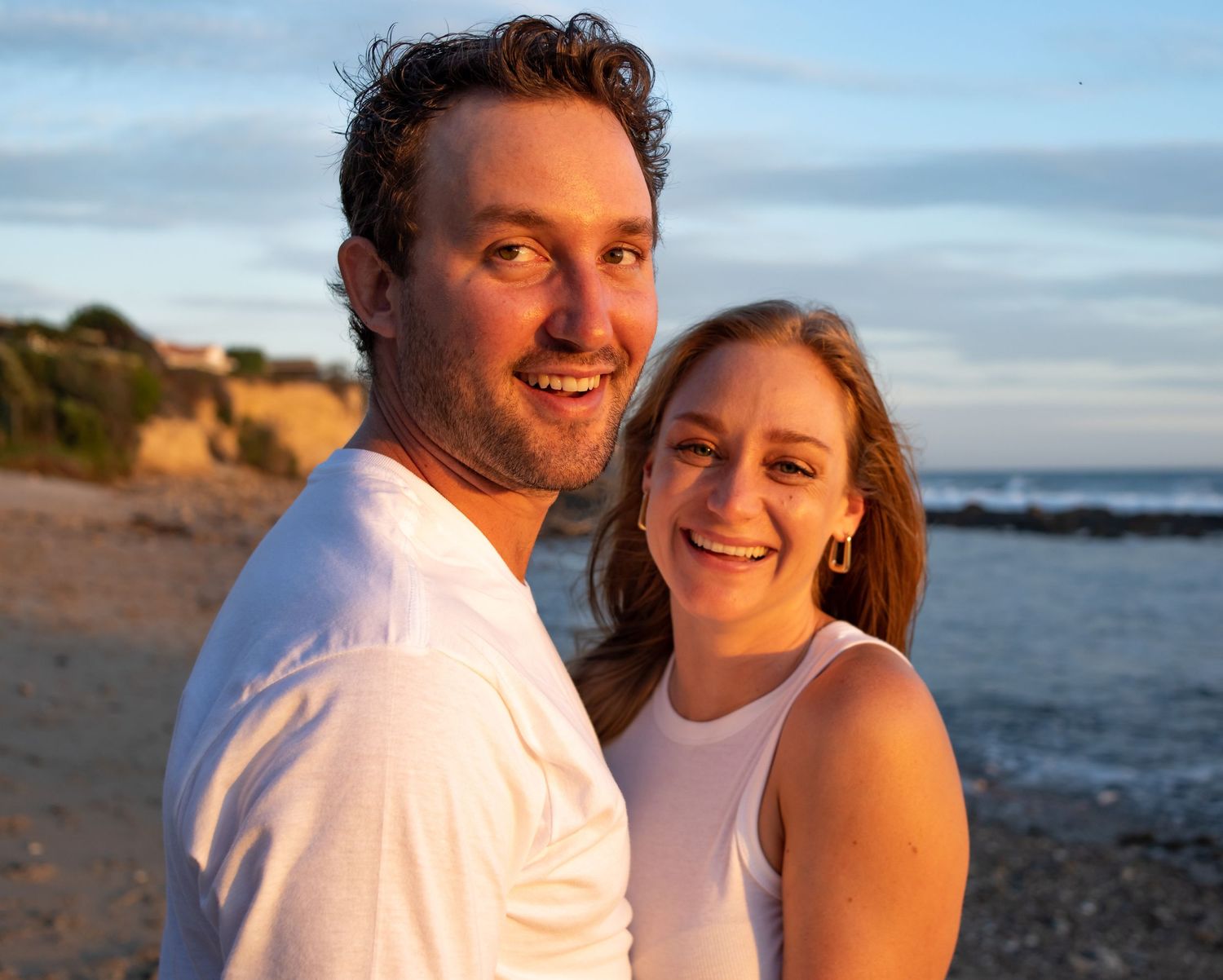 A couple shares joyful moments together at the beach during sunset, creating a series of candid photographs.
