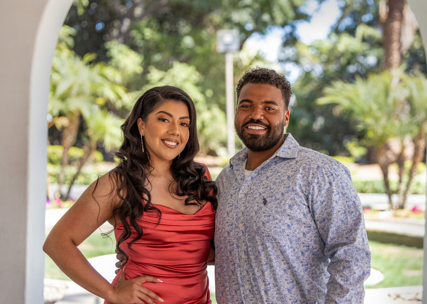Casual outdoor couples photoshoot in coral and grey outfits.