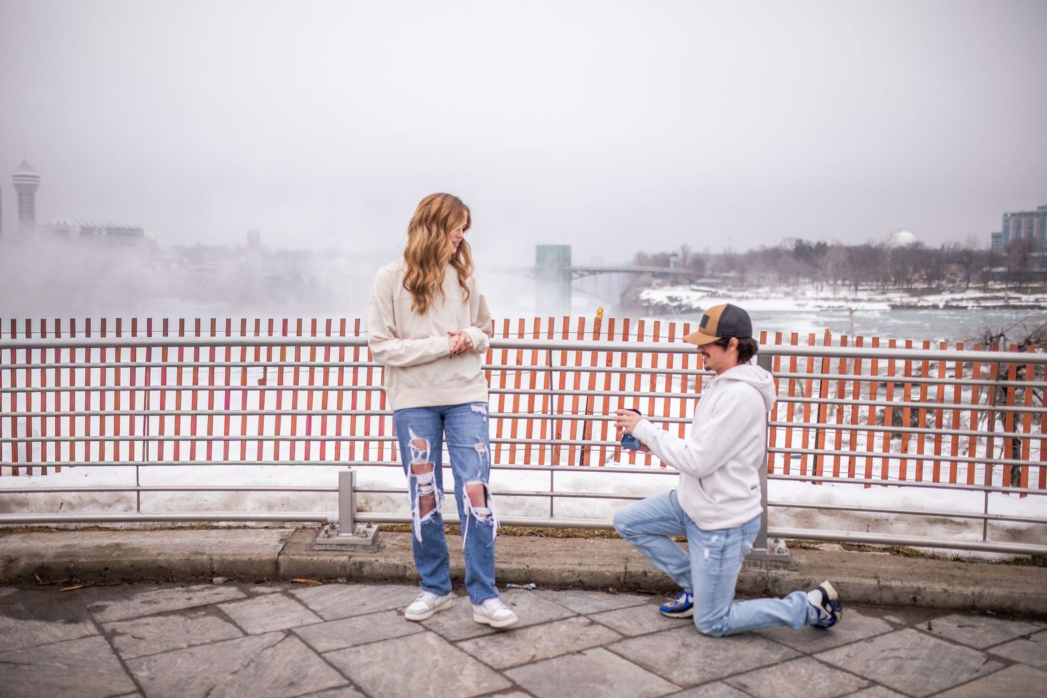 Hunter gets down on one knee in a surprise proposal in front of Niagara Falls, New York during their engagement session.