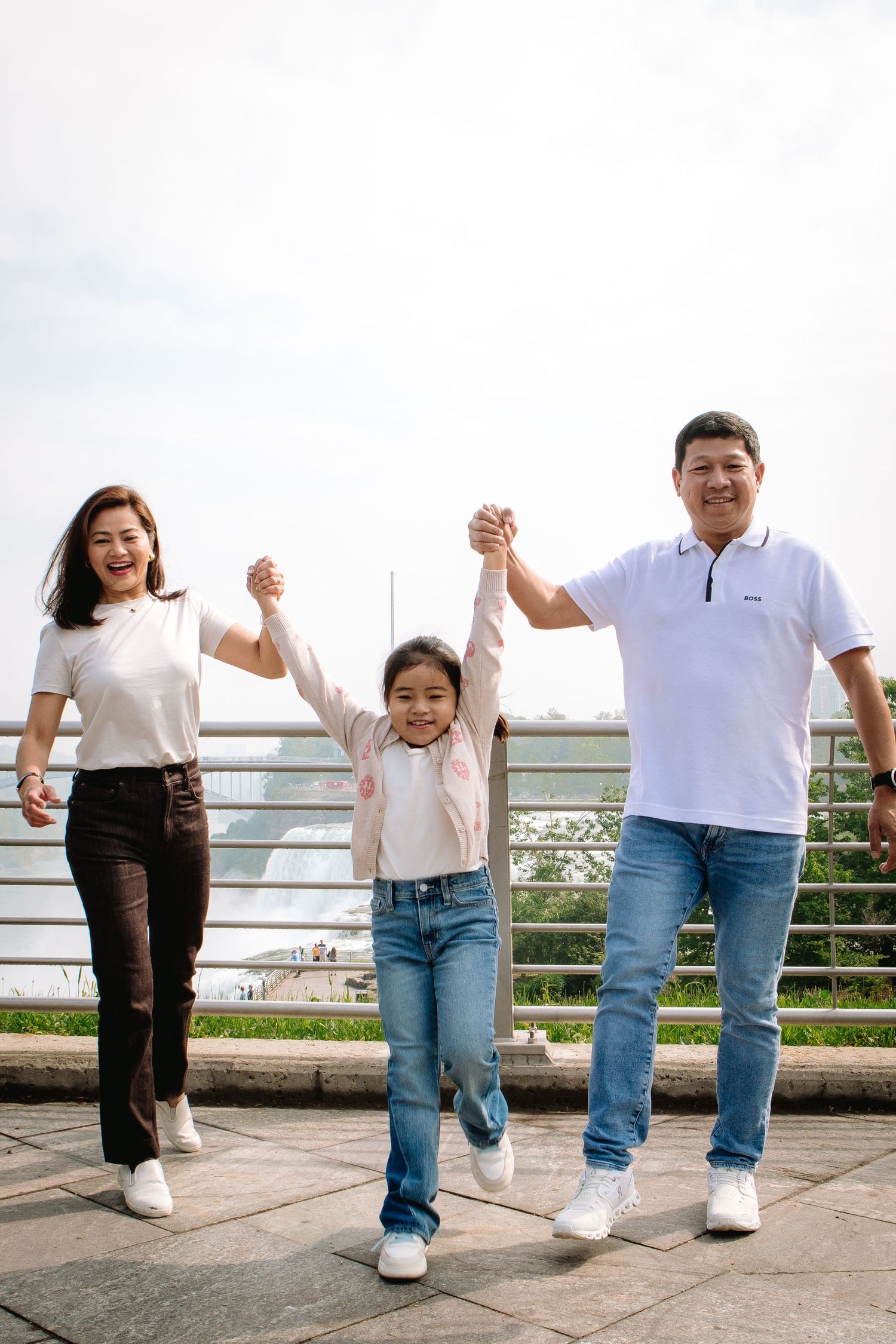 Family visiting Niagara Falls walks together during their Niagara Falls Family Portrait Session.