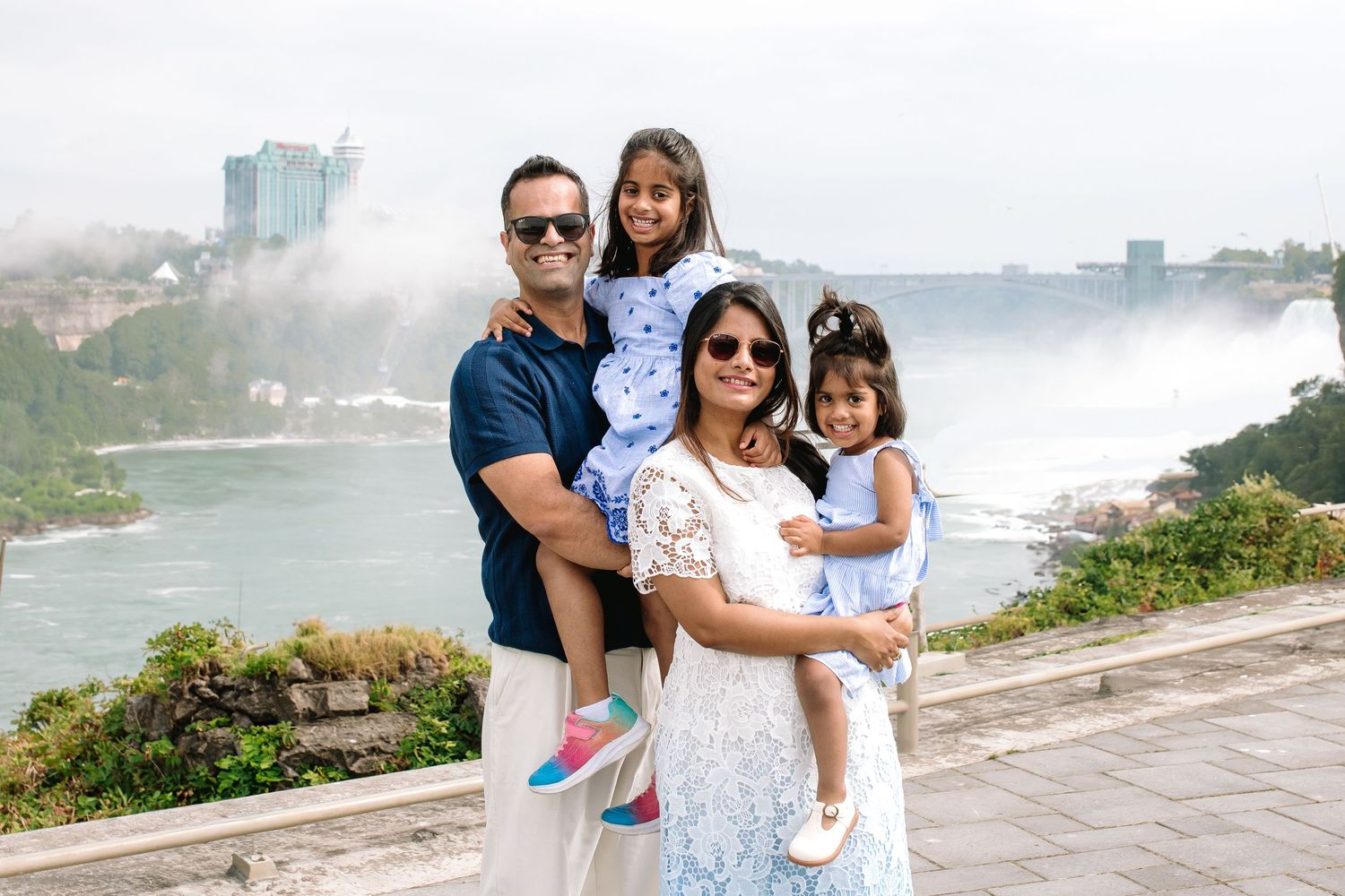 Family visiting Niagara Falls snuggles together during their Niagara Falls Family Portrait Session.