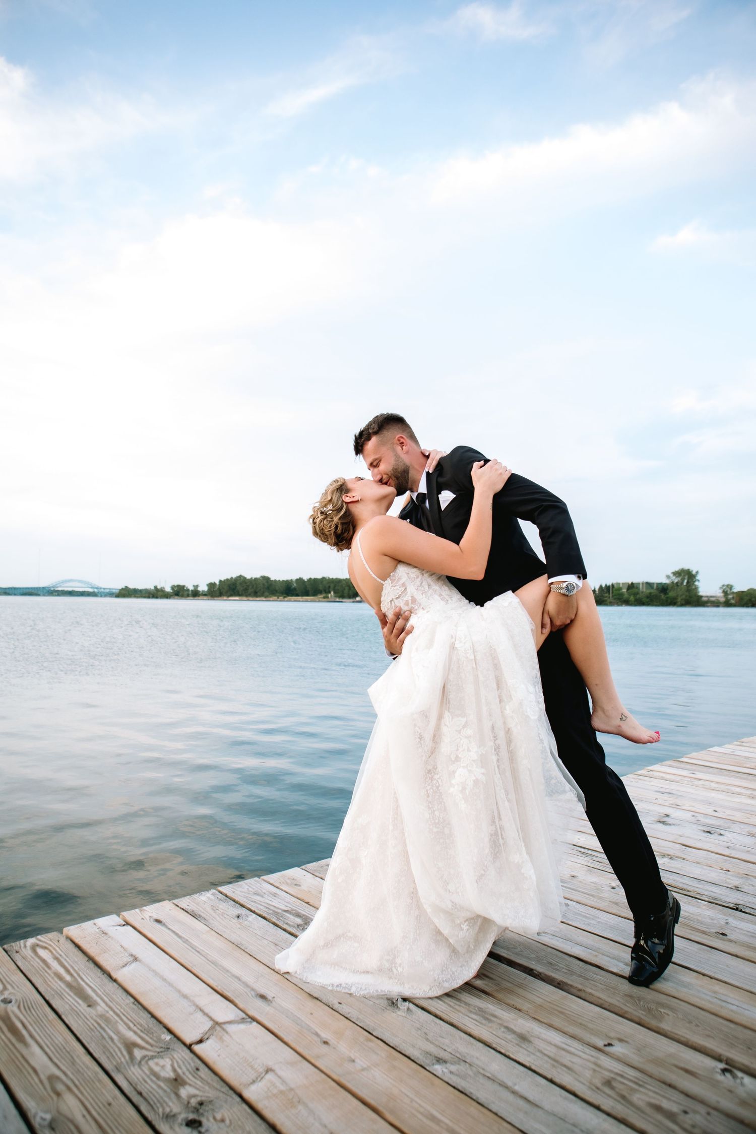 Bride and Groom share a dip kiss on a dock at The Buffalo Launch Club after their wedding ceremony.