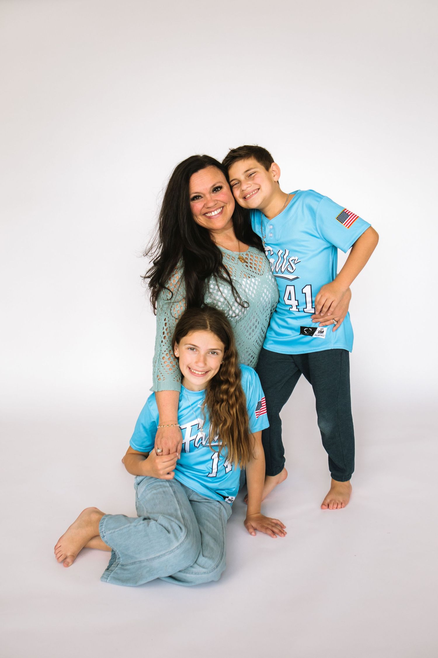 Mom and children pose on white backdrop in studio at The Workspace at The Wurlitzer, Jess Trankle Images studio in North Tonawanda, New York