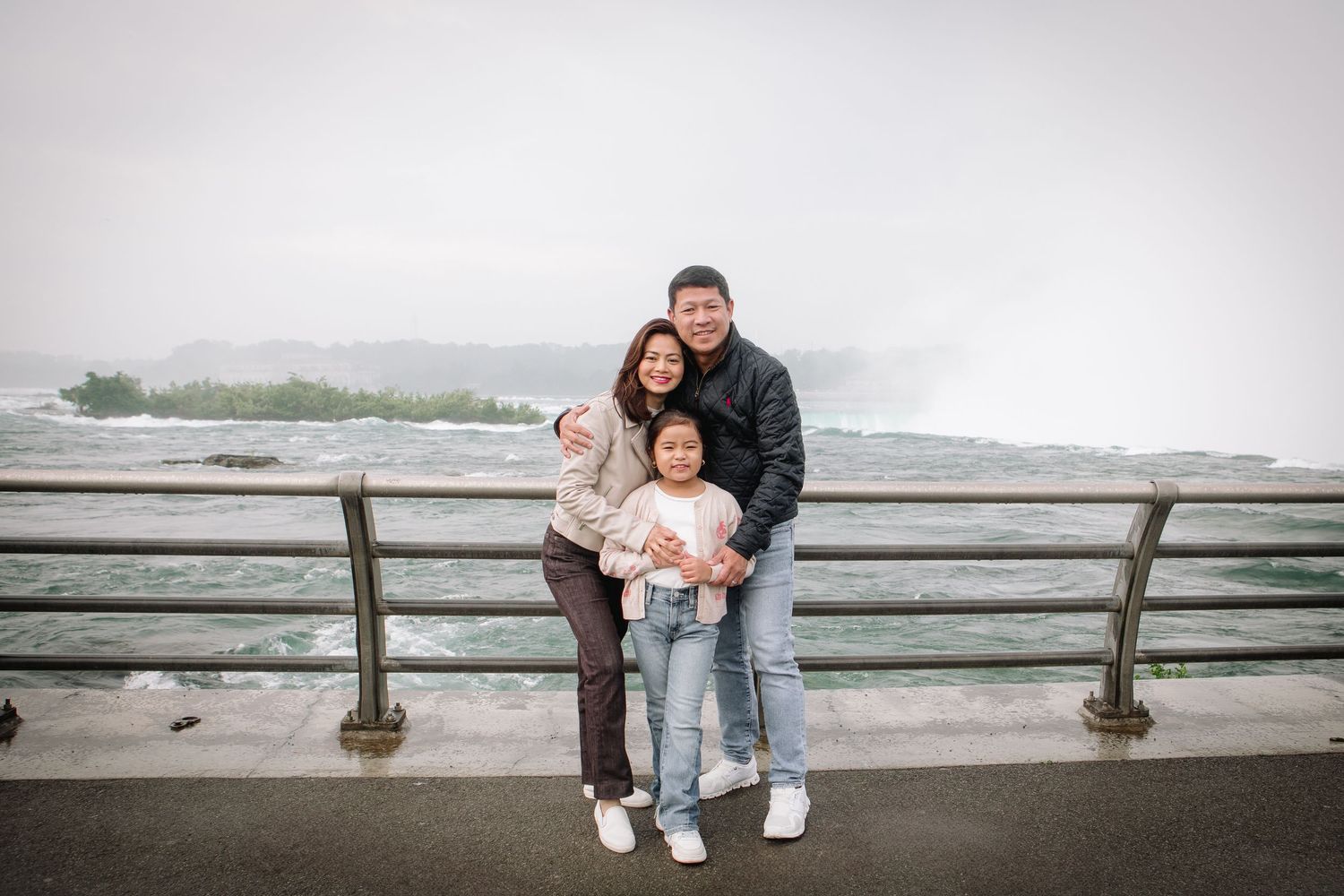 Family visiting Niagara Falls poses together during their Niagara Falls Family Portrait Session.