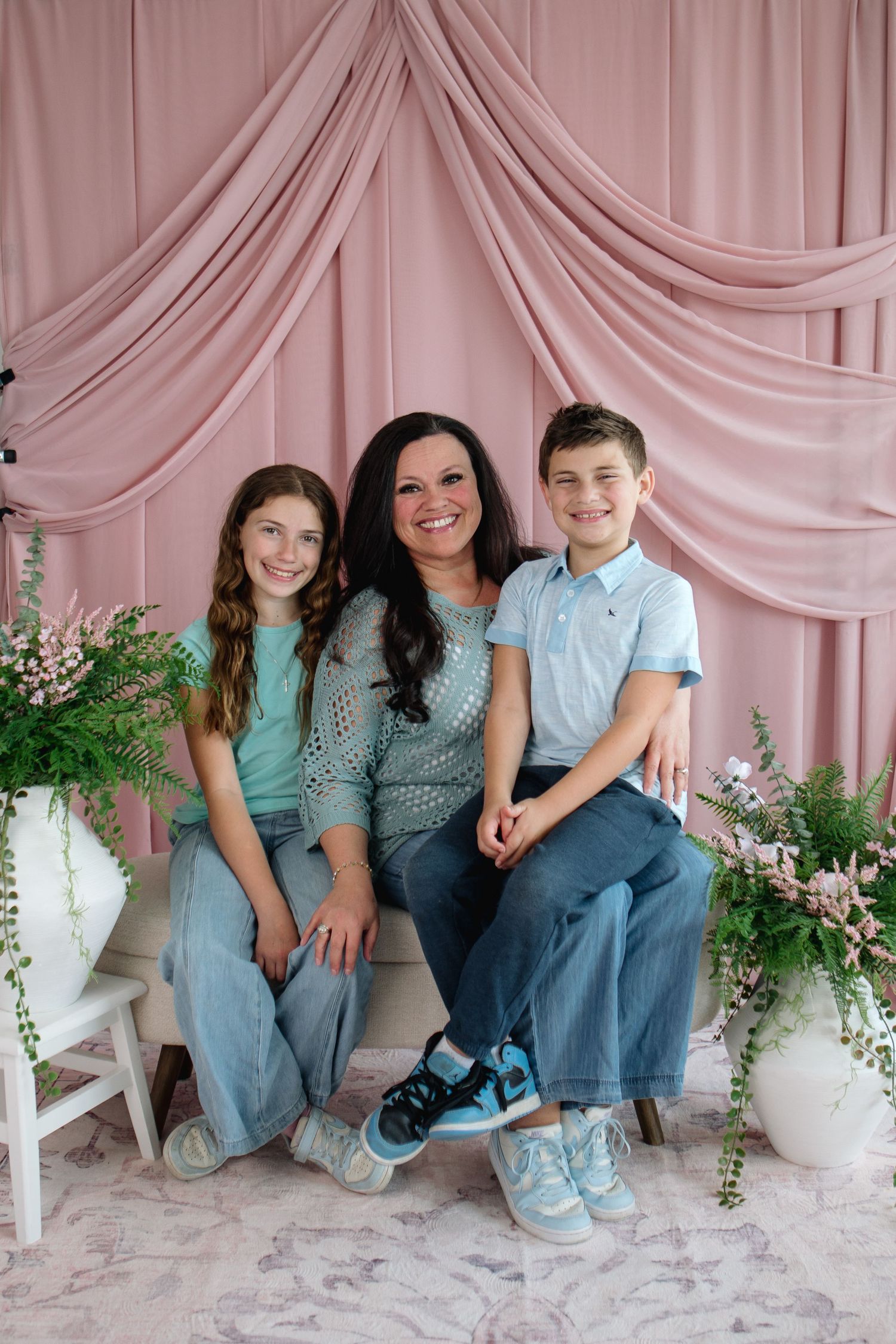 Mom and two young children pose together at The Workspace at the Wurlitzer portrait studio in North Tonawanda, New York