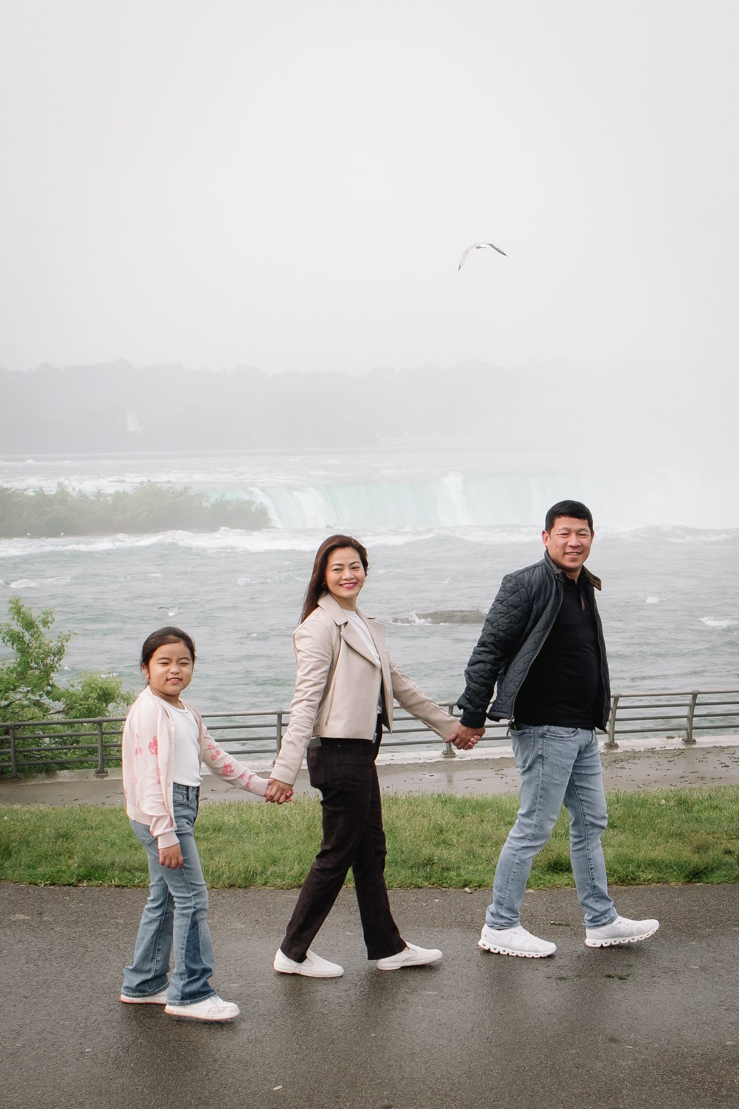 Family visiting Niagara Falls walks together during their Niagara Falls Family Portrait Session.