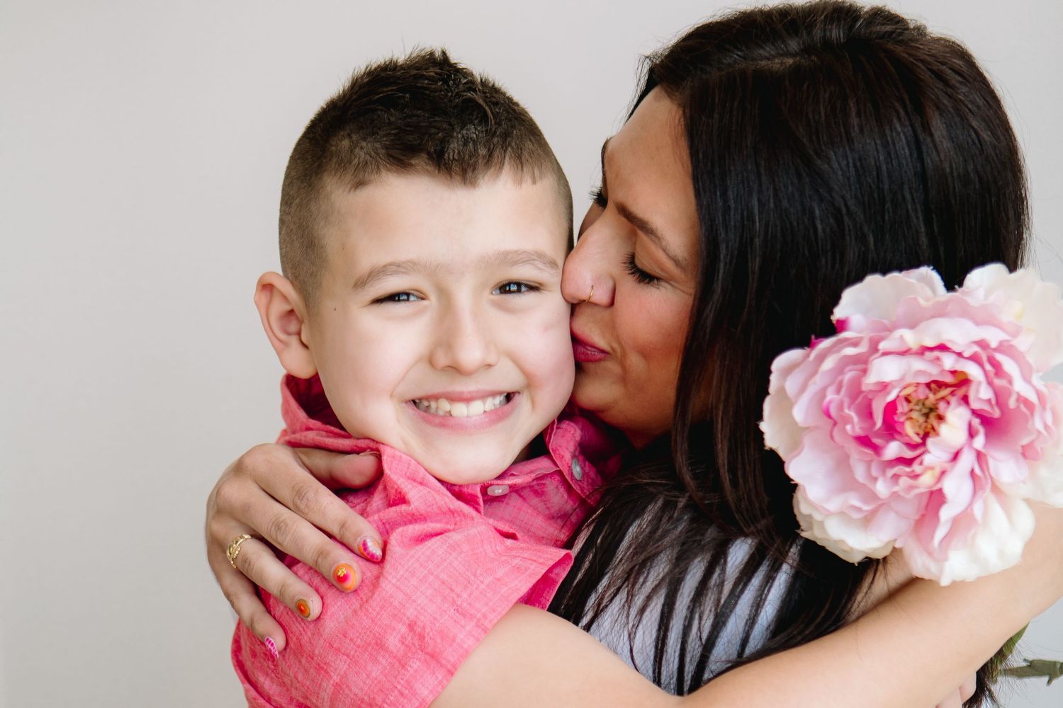 Mom gives son a kiss on the cheek at jess trankle Images portrait studio in North Tonawanda, New York