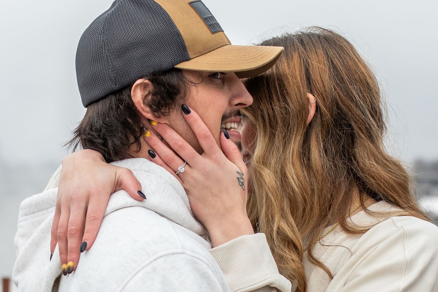 Hunter and Elyse embrace in front of Niagara Falls, New York after Hunter proposed during their proposal session.
