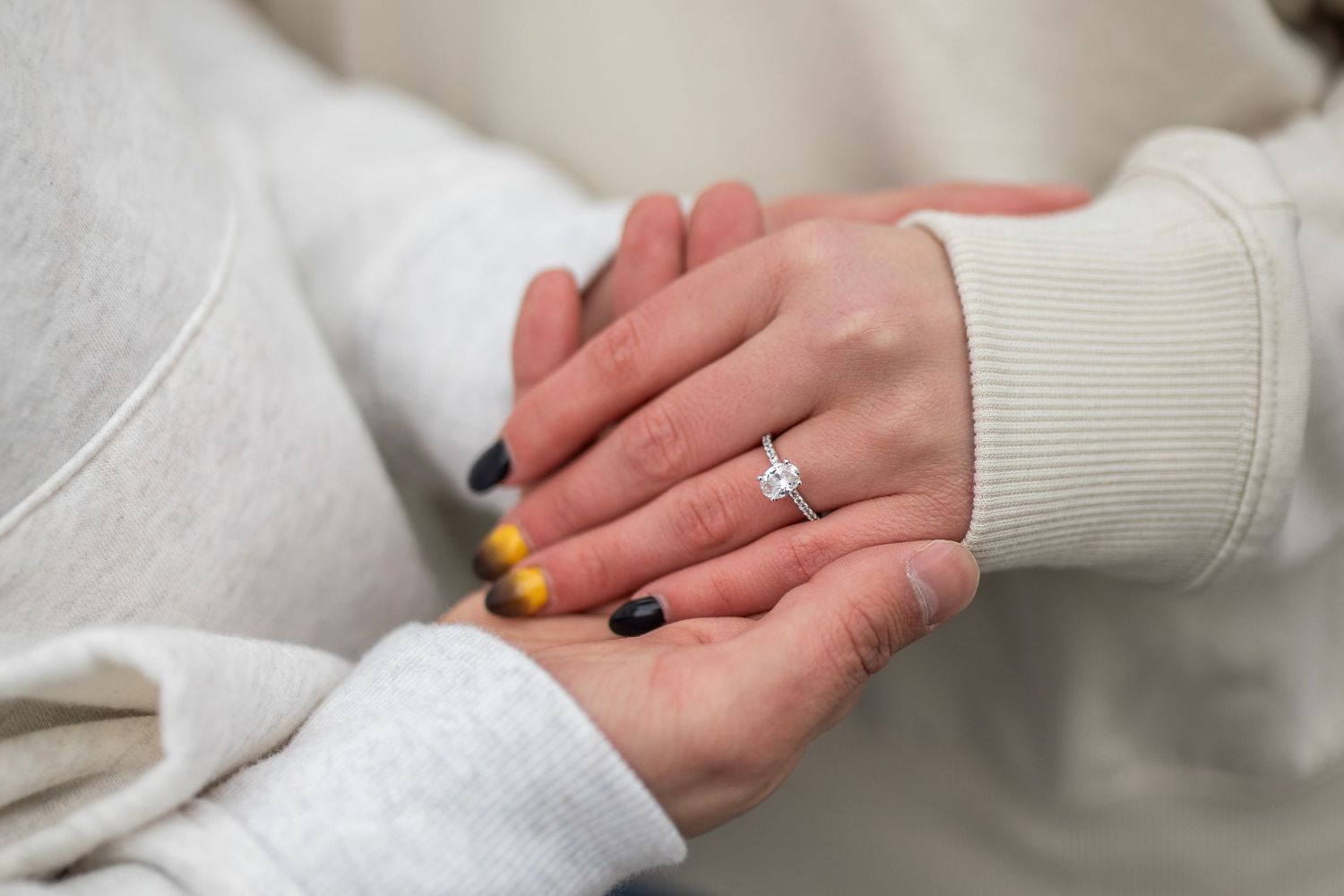 Newly engaged couple displays their engagement ring in front of Niagara Falls, New York after Hunter proposed.