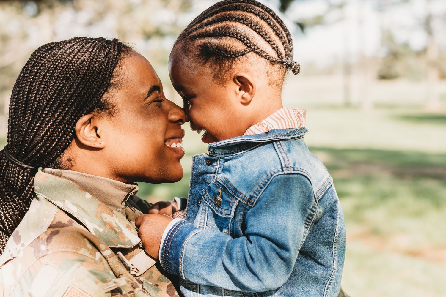 A loving parent and child share tender moments together outdoors in a series of candid photos.