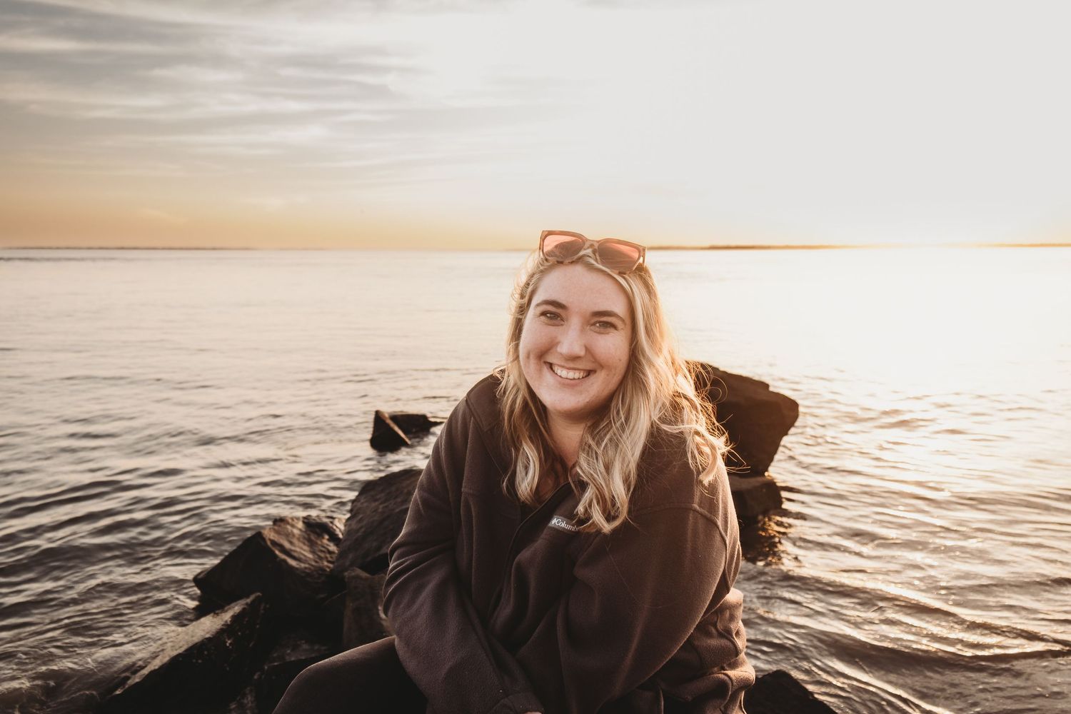 Serene sunset portrait session by the ocean with golden hour lighting.