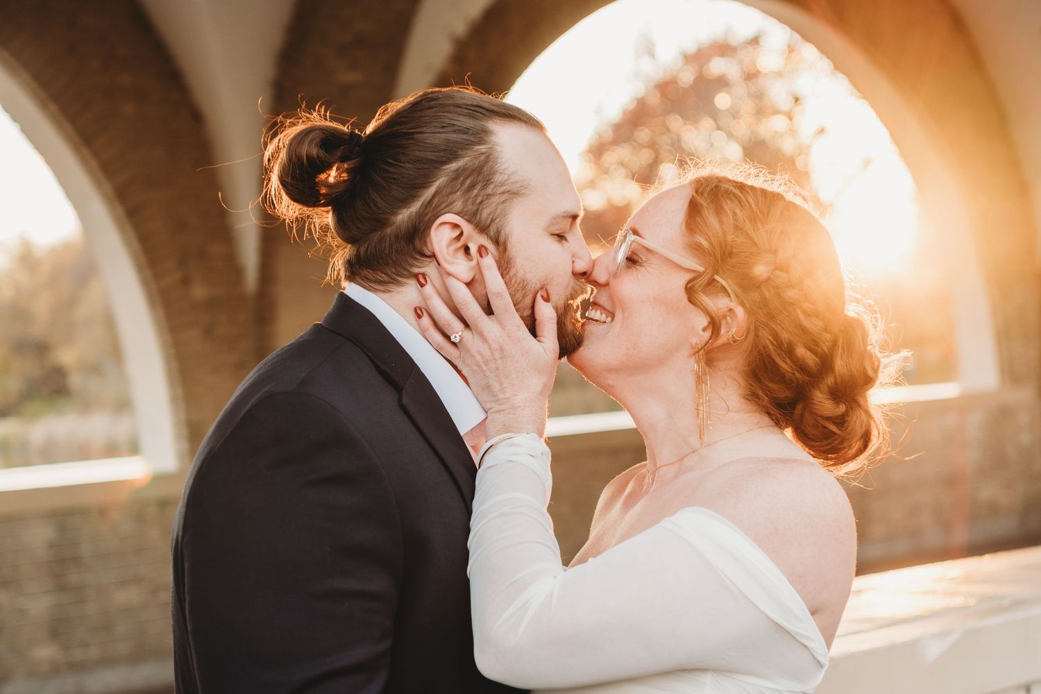 Romantic sunset photoshoot with golden light streaming through an archway.