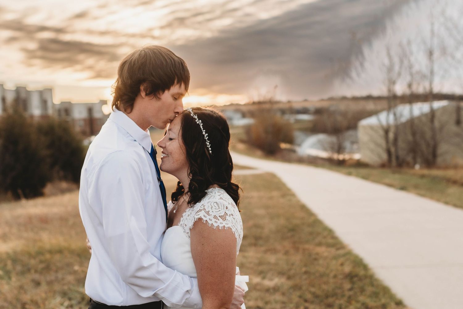 Romantic couples portraits along a path during golden hour sunset.