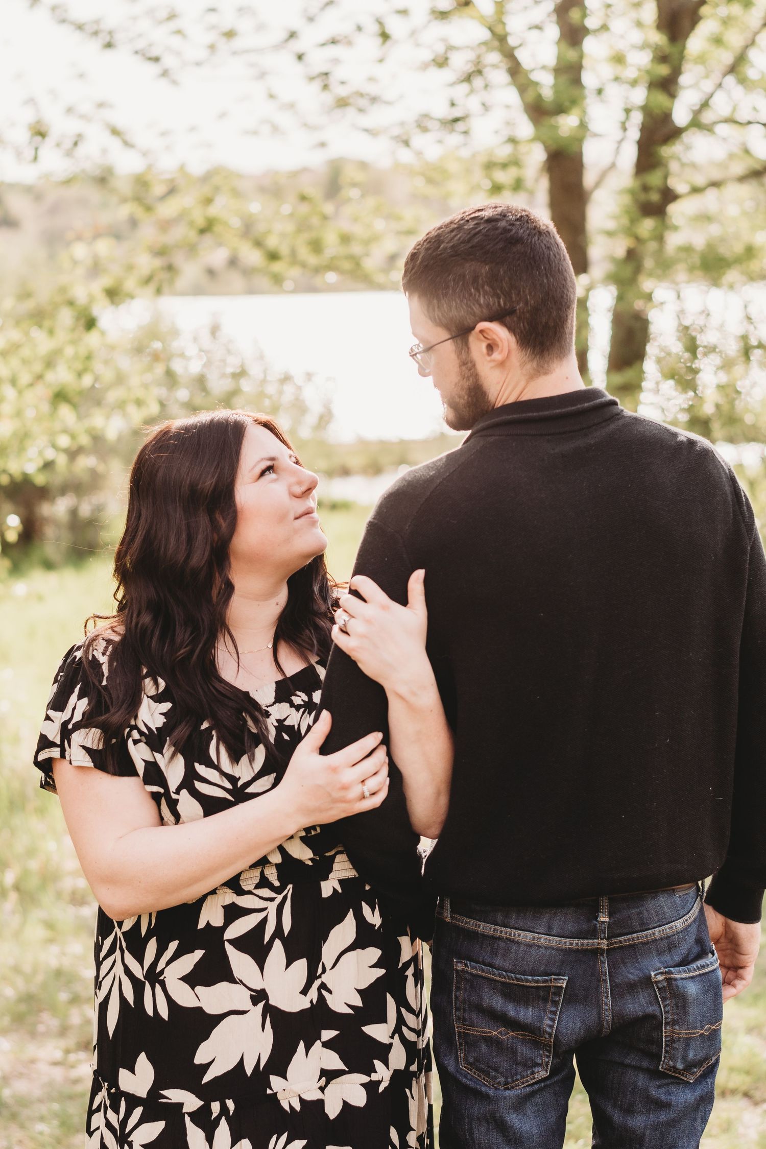 A couple embraces in a series of intimate poses against a natural outdoor backdrop.