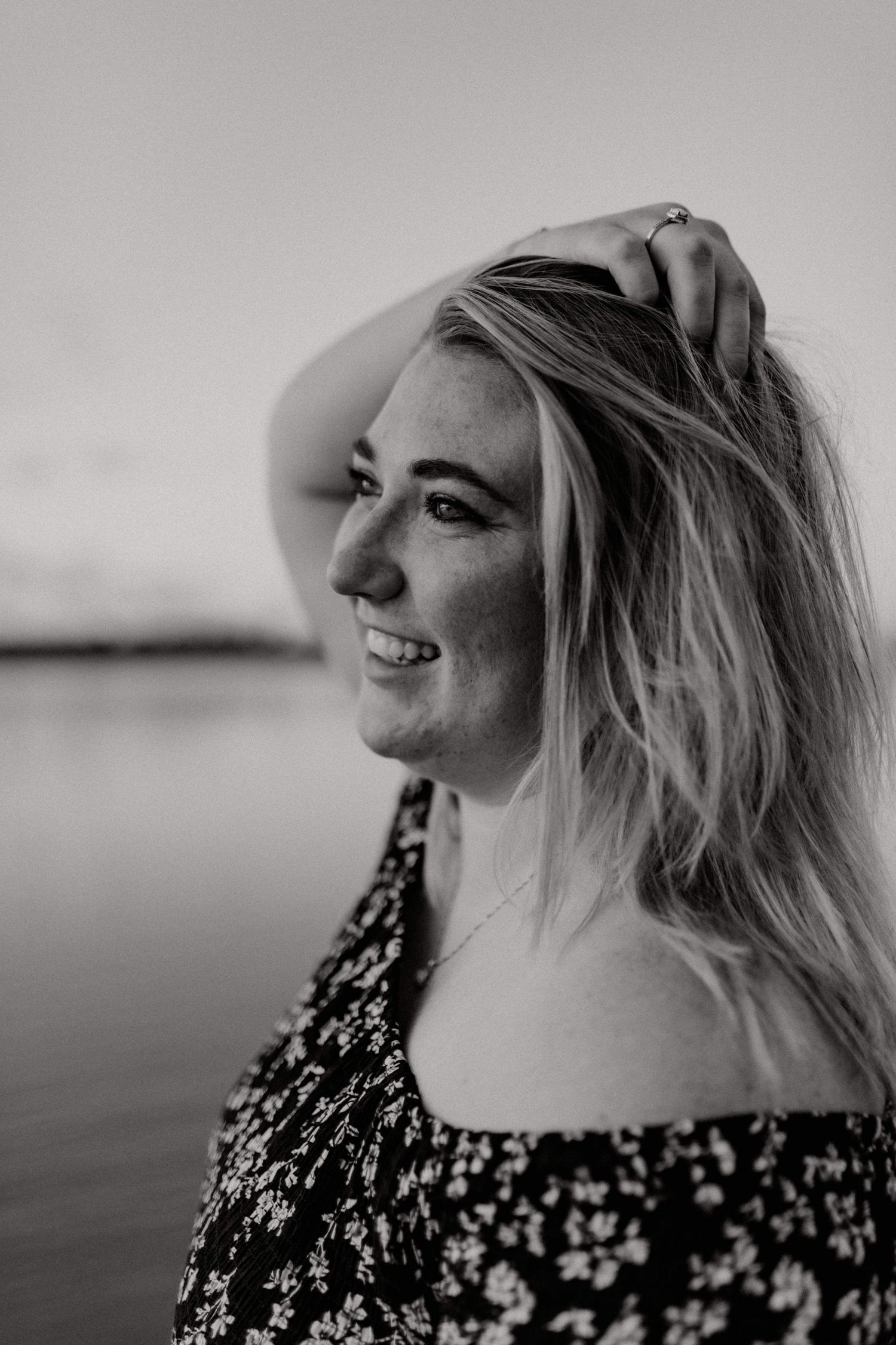 Black and white portrait series showing different expressions in a floral patterned top.