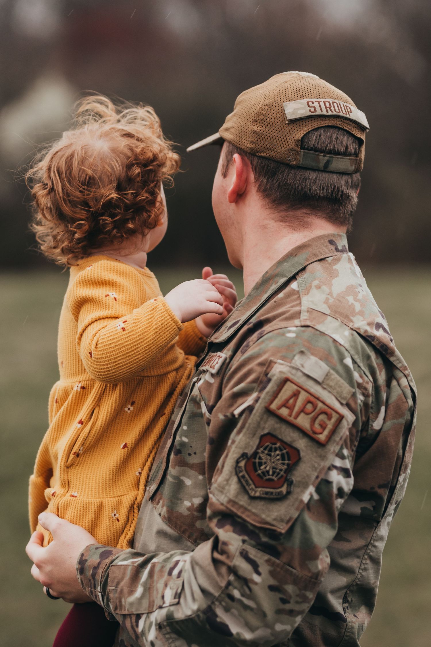 A heartwarming sequence of photos shows a small child in a yellow sweater embracing a person in military fatigues.