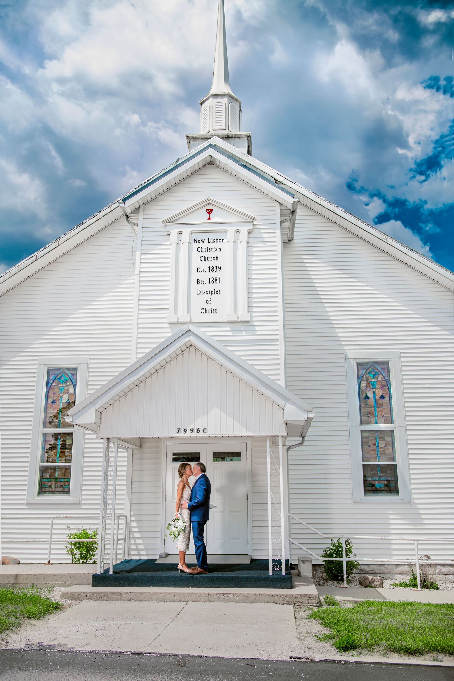 couple kissing in front of church