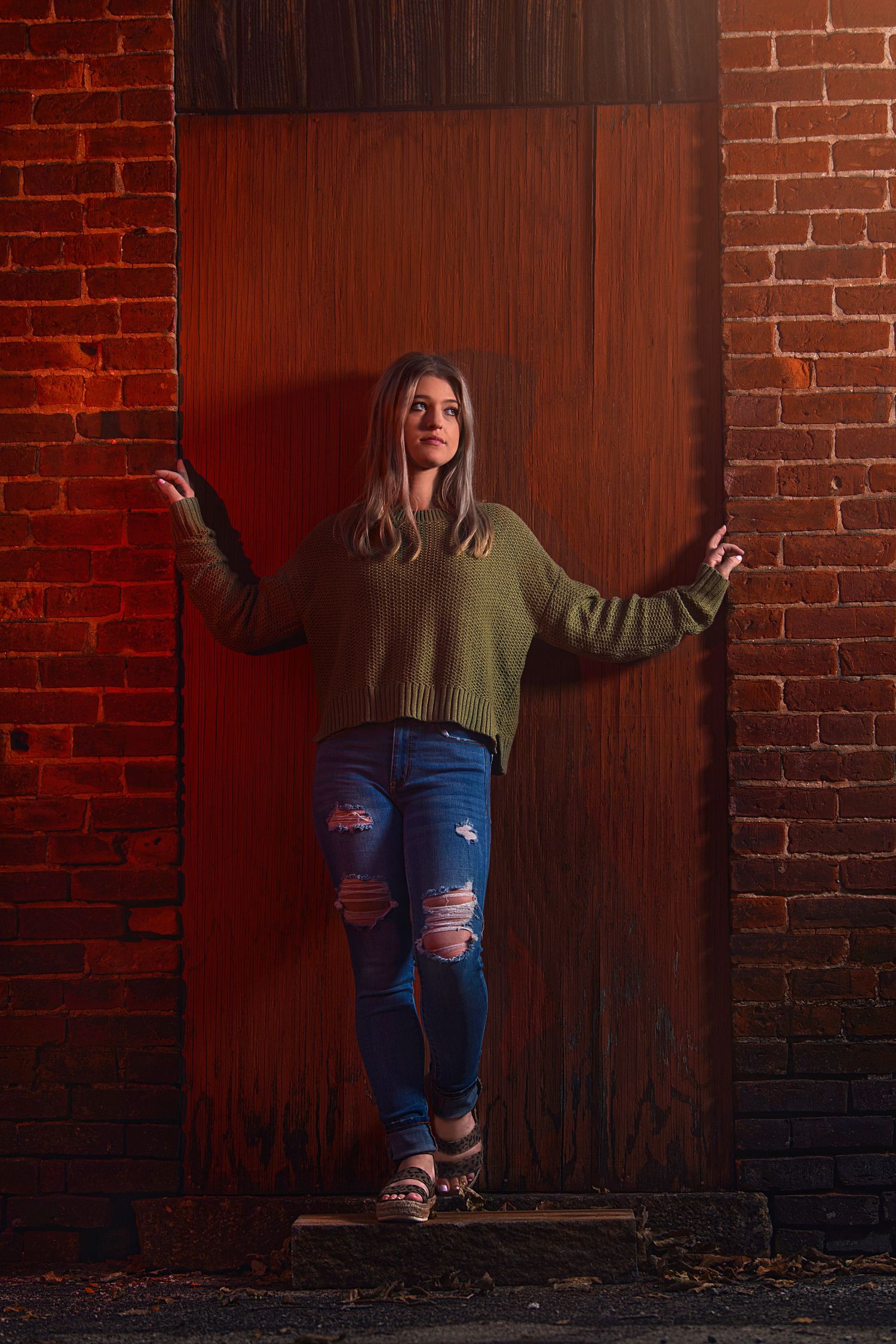 senior girl against brick