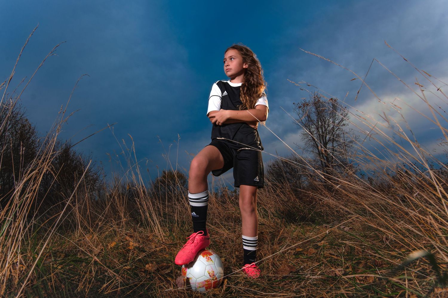 young girl with soccer ball outside