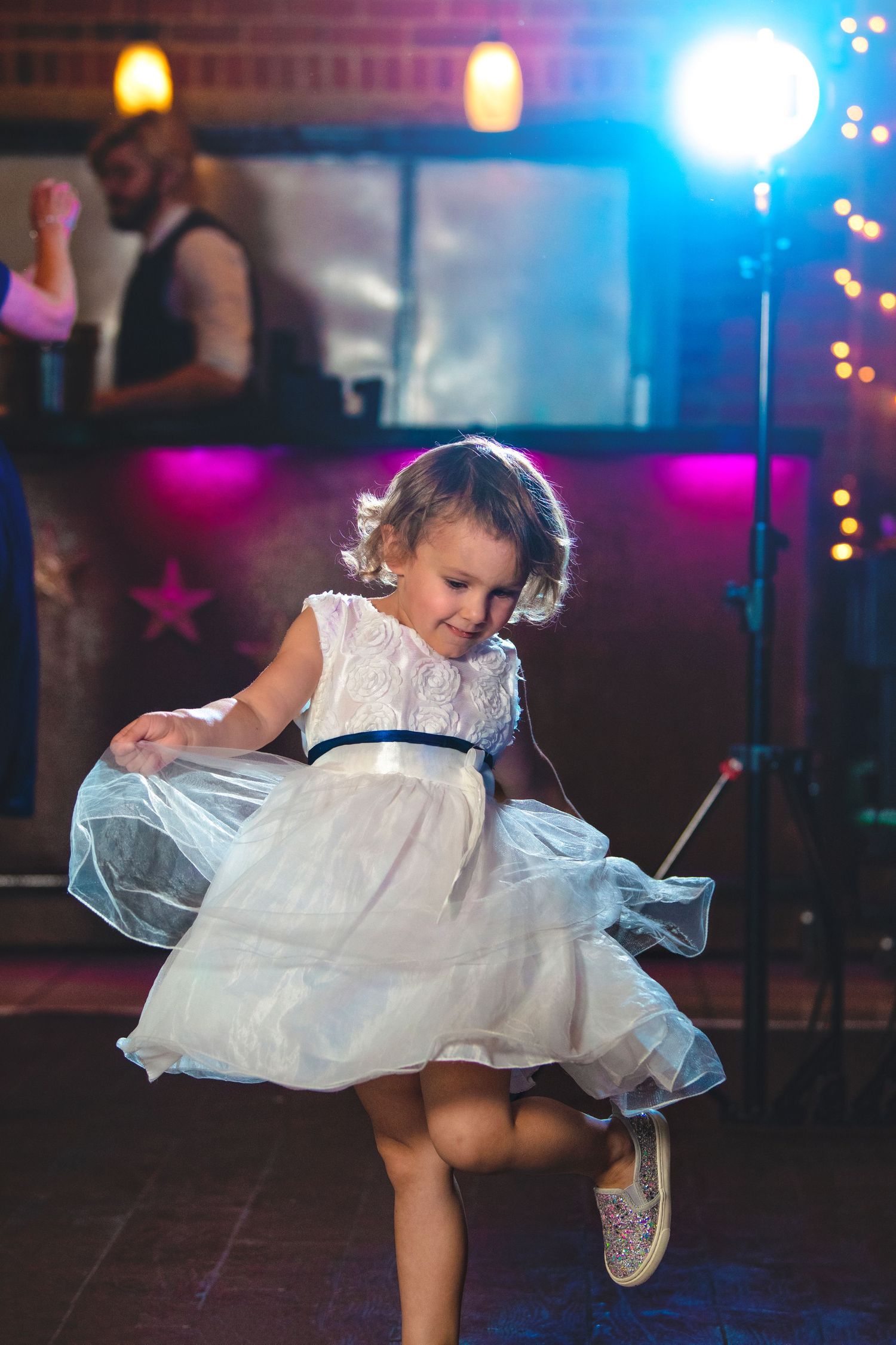 flower girl dancing at reception