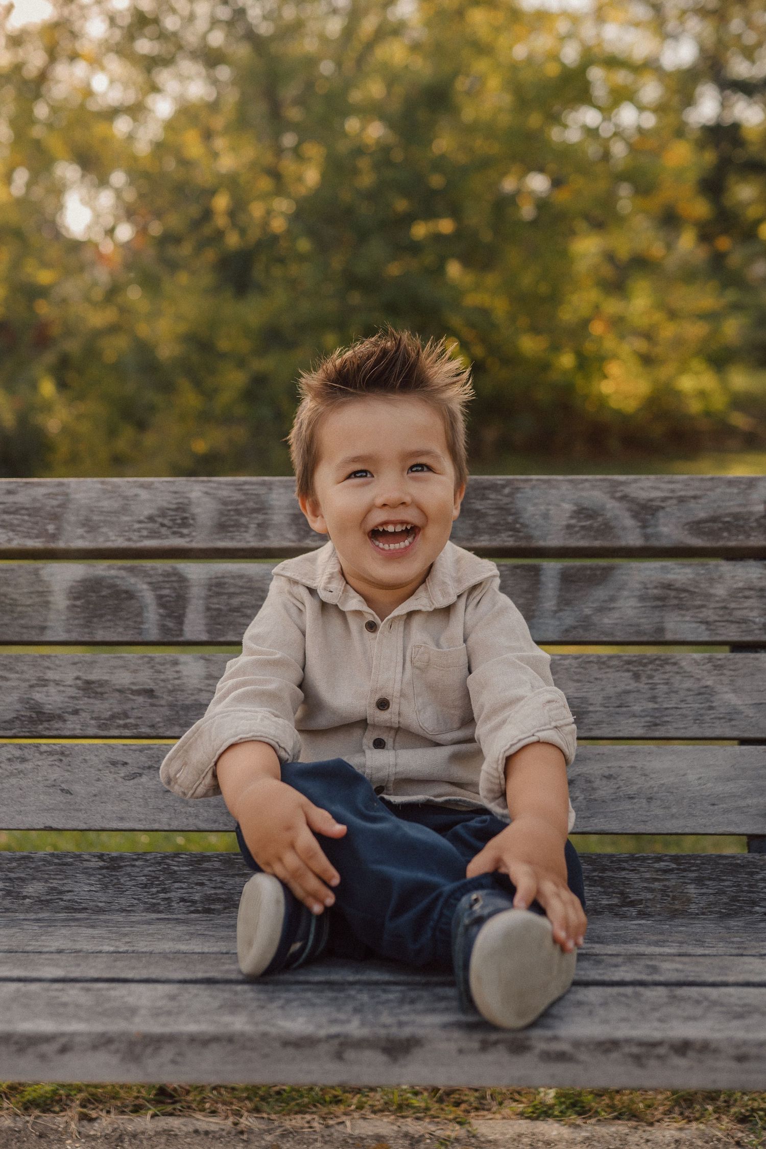 A sequence of joyful expressions captured on a wooden bench in an autumn park setting.