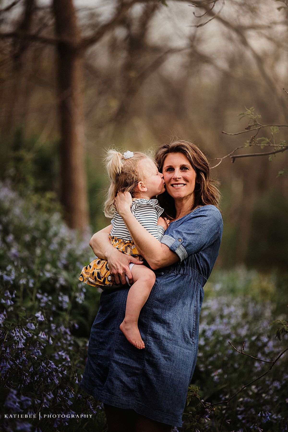 Natural outdoor portrait in denim against a backdrop of purple wildflowers.