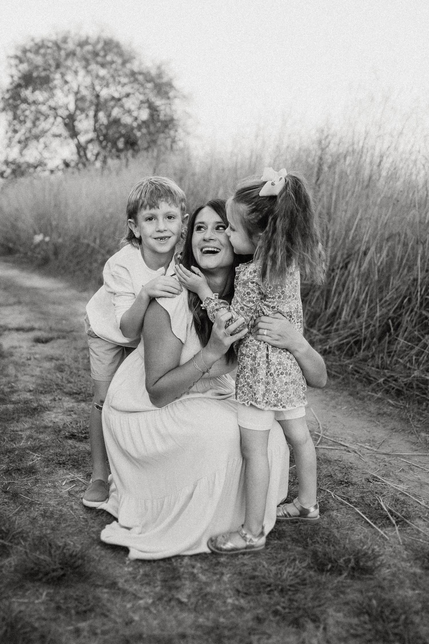 Black and white photo of joyful group moment on outdoor trail.