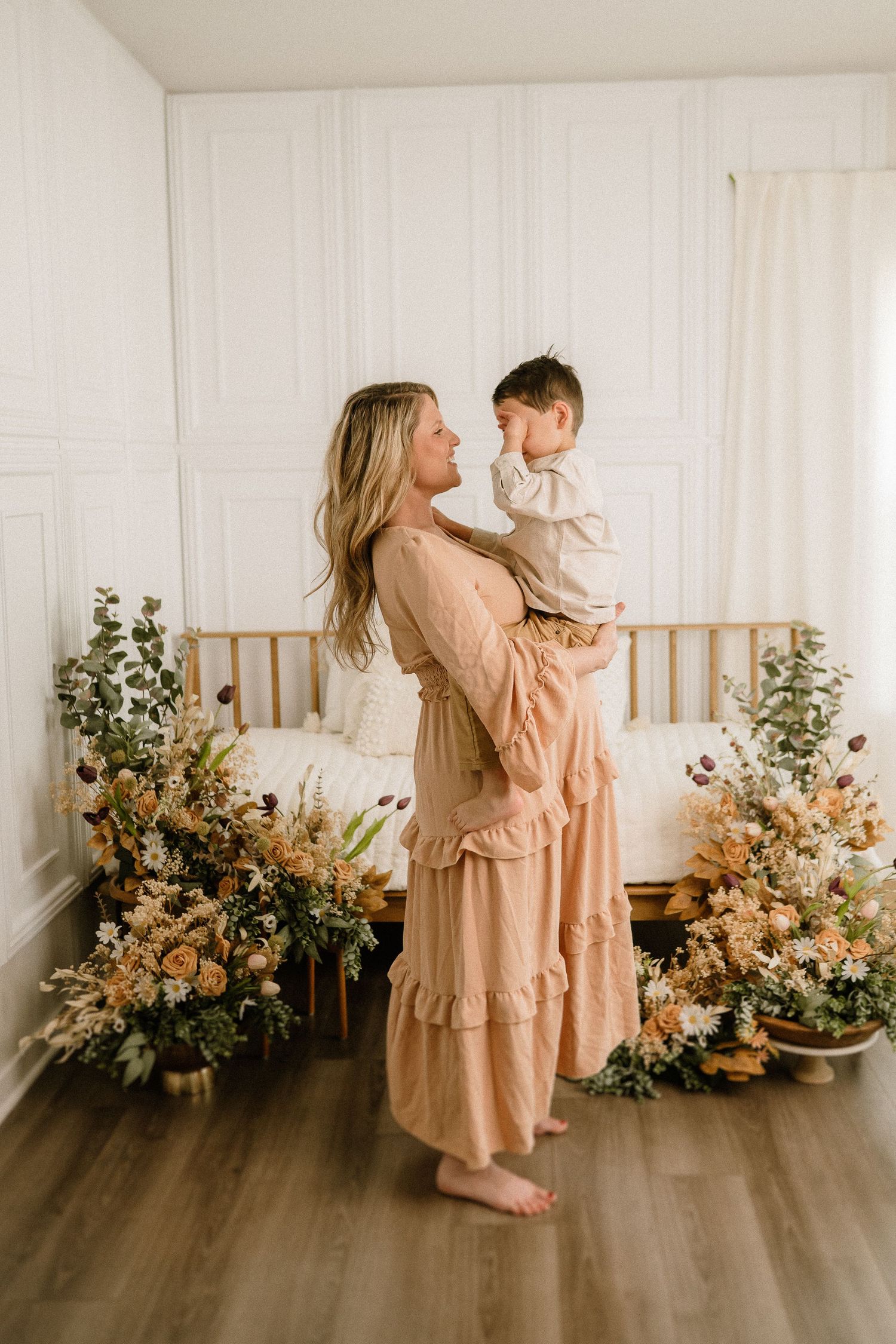 A heartwarming series of photos showing parent and child in matching peach dresses posing with floral arrangements.