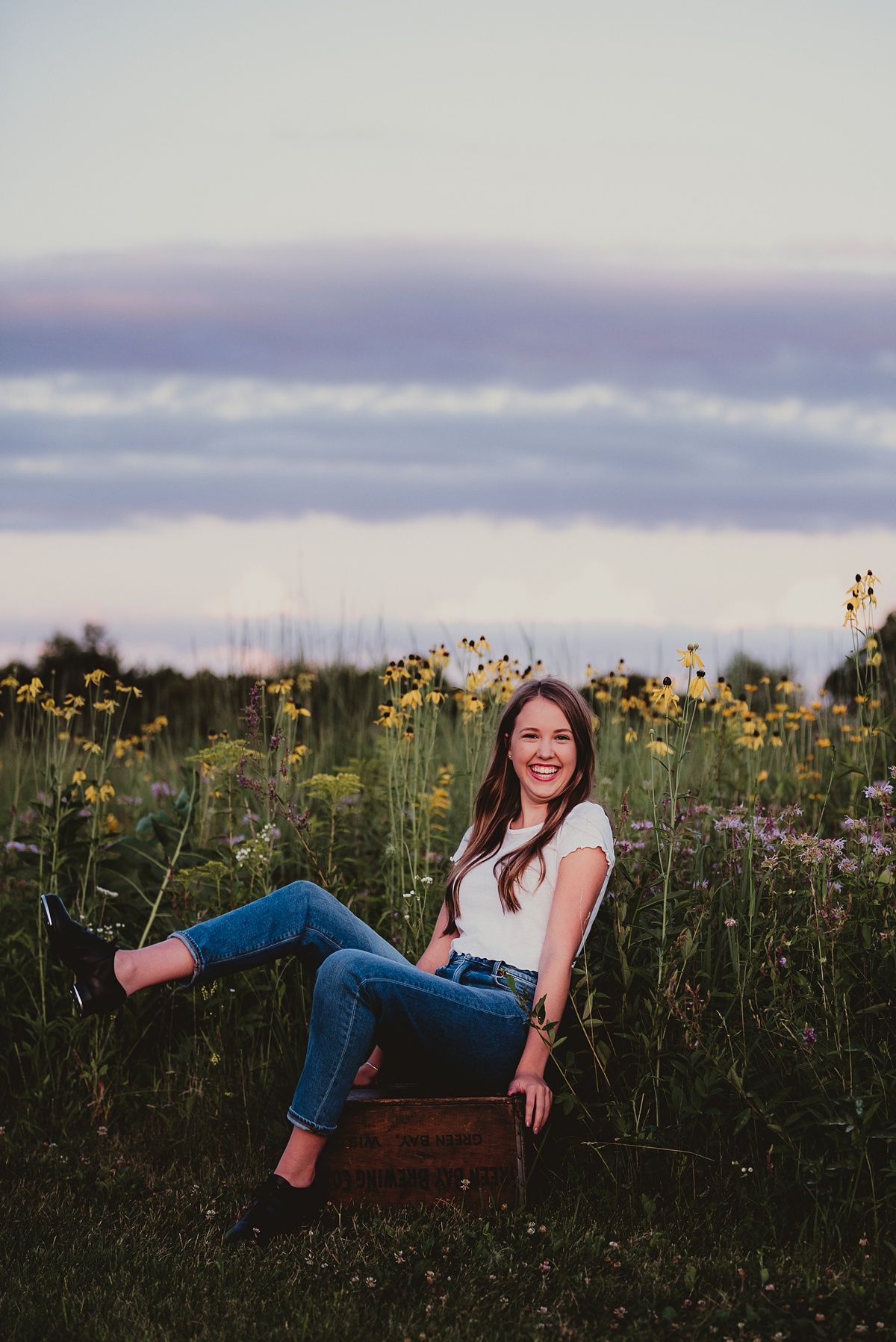 A casual summer portrait in a wildflower field at dusk.