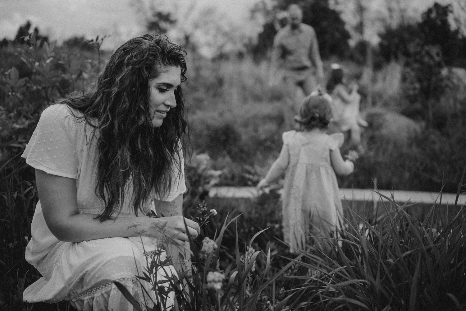 A black and white portrait showing a peaceful moment in a wild meadow setting.
