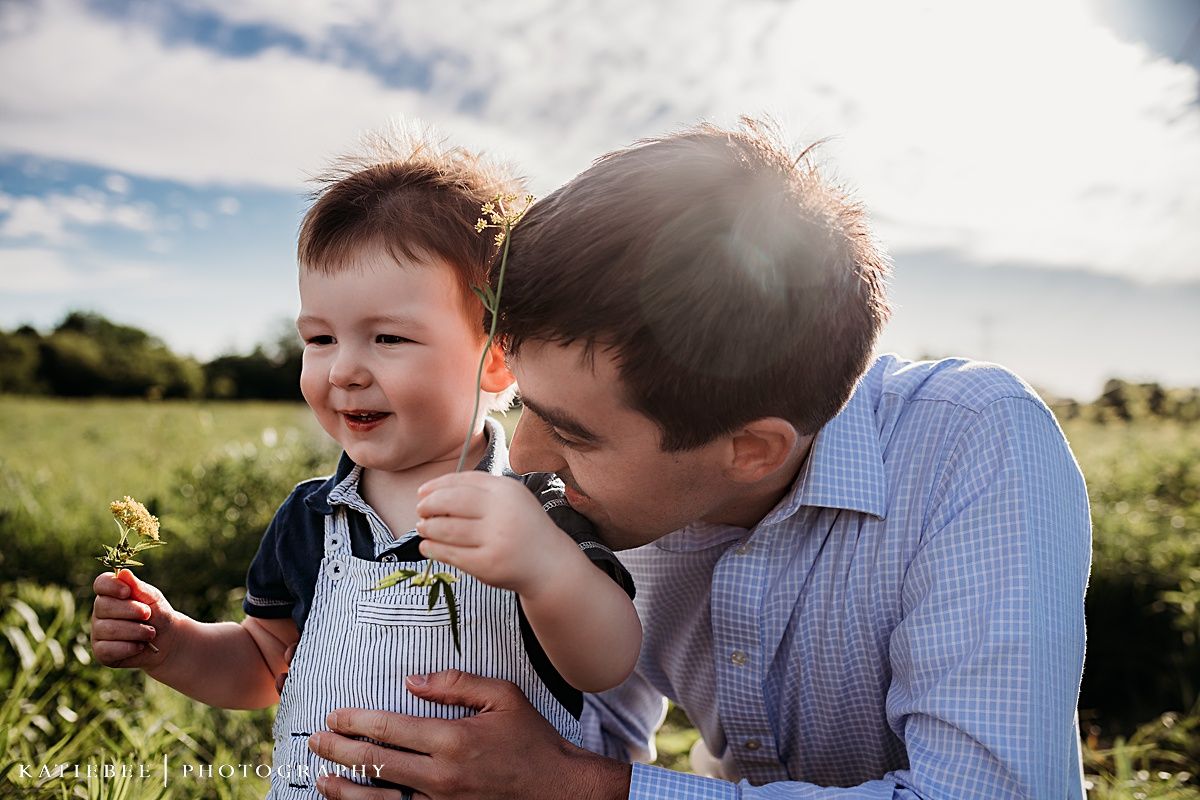 Joyful playtime moment shared in an open field with wildflowers and sunshine.