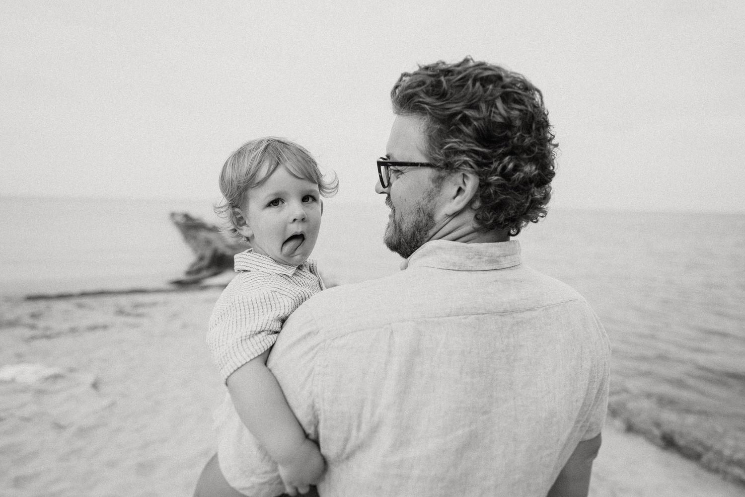 An intimate black and white portrait captured at the beach.