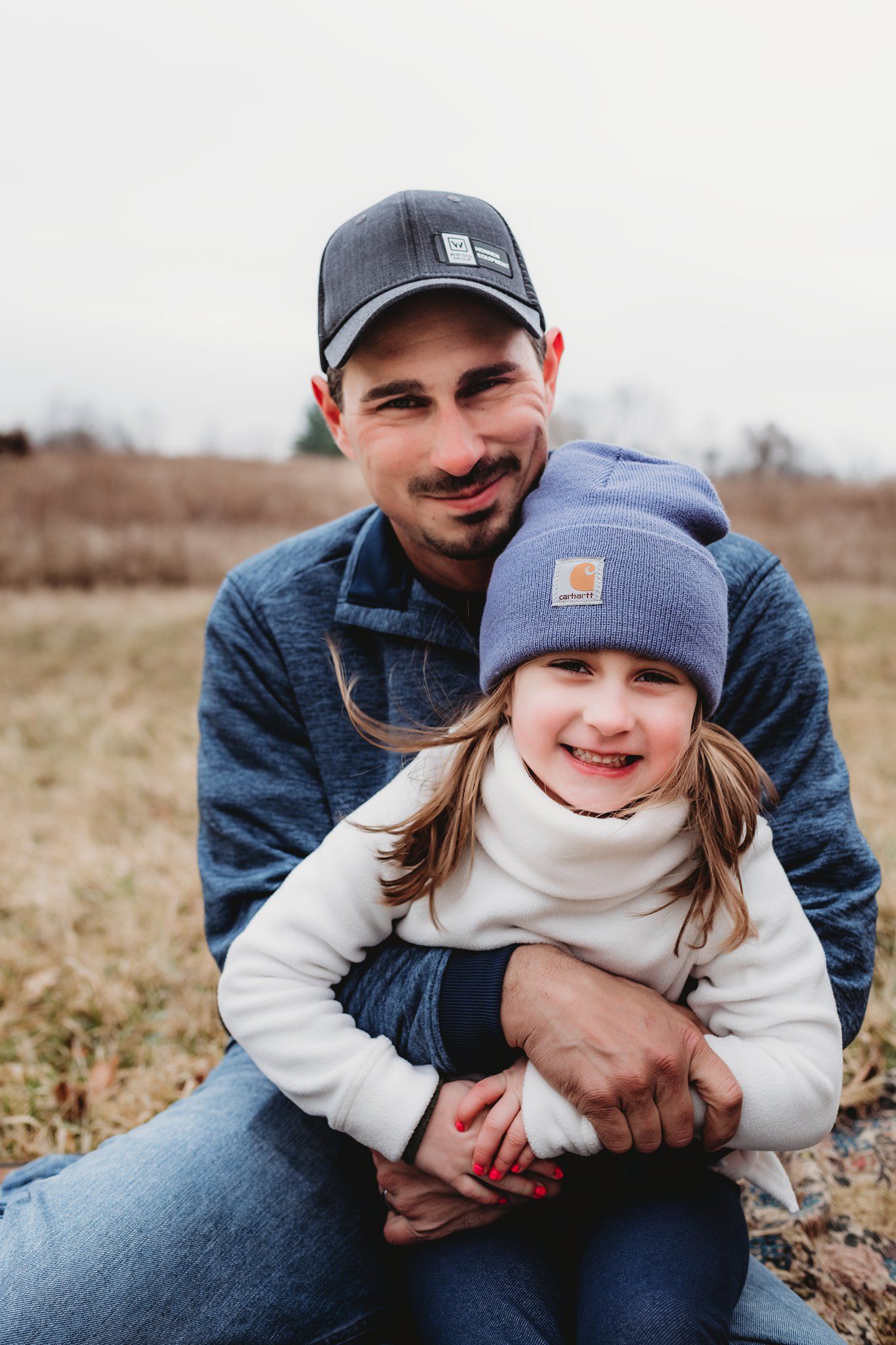 Warm embrace captured outdoors with winter hats and casual clothing.
