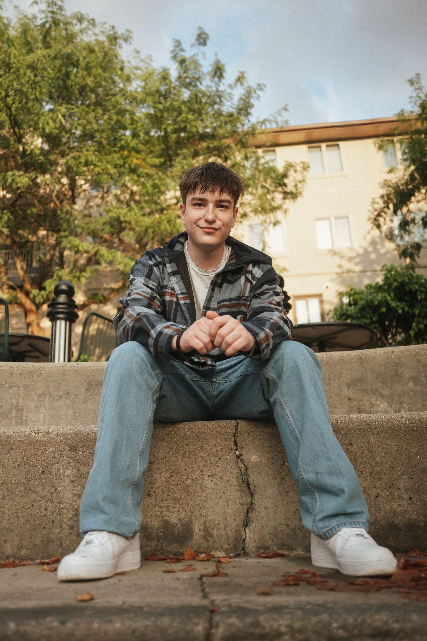 A series of photos showing someone sitting on concrete steps wearing jeans and white sneakers in an outdoor setting.