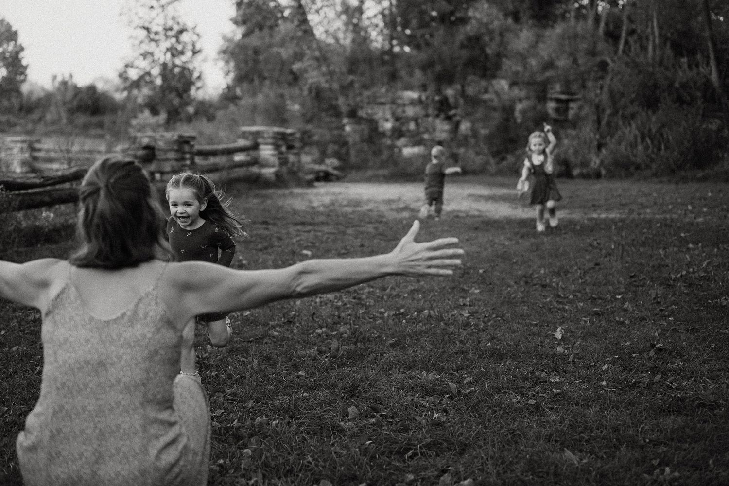 A series of black and white photos showing children playing and running in a grassy outdoor area.
