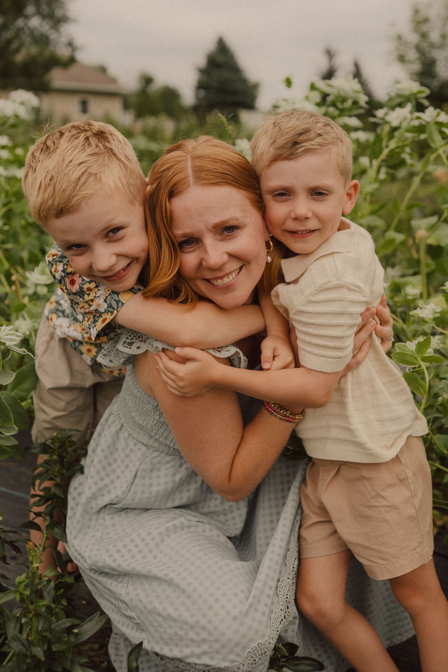 Loving family moment captured in a series of candid photos showing warm embraces against a natural outdoor backdrop.
