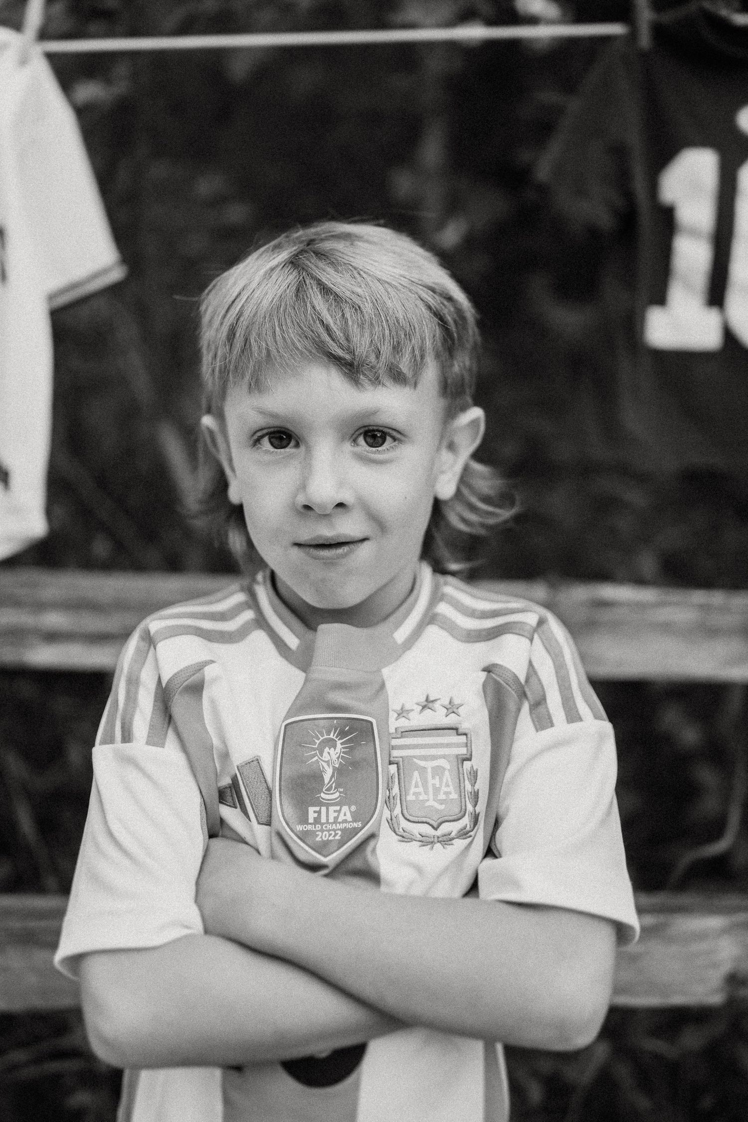 Black and white close-up portrait wearing Argentina national team soccer jersey.