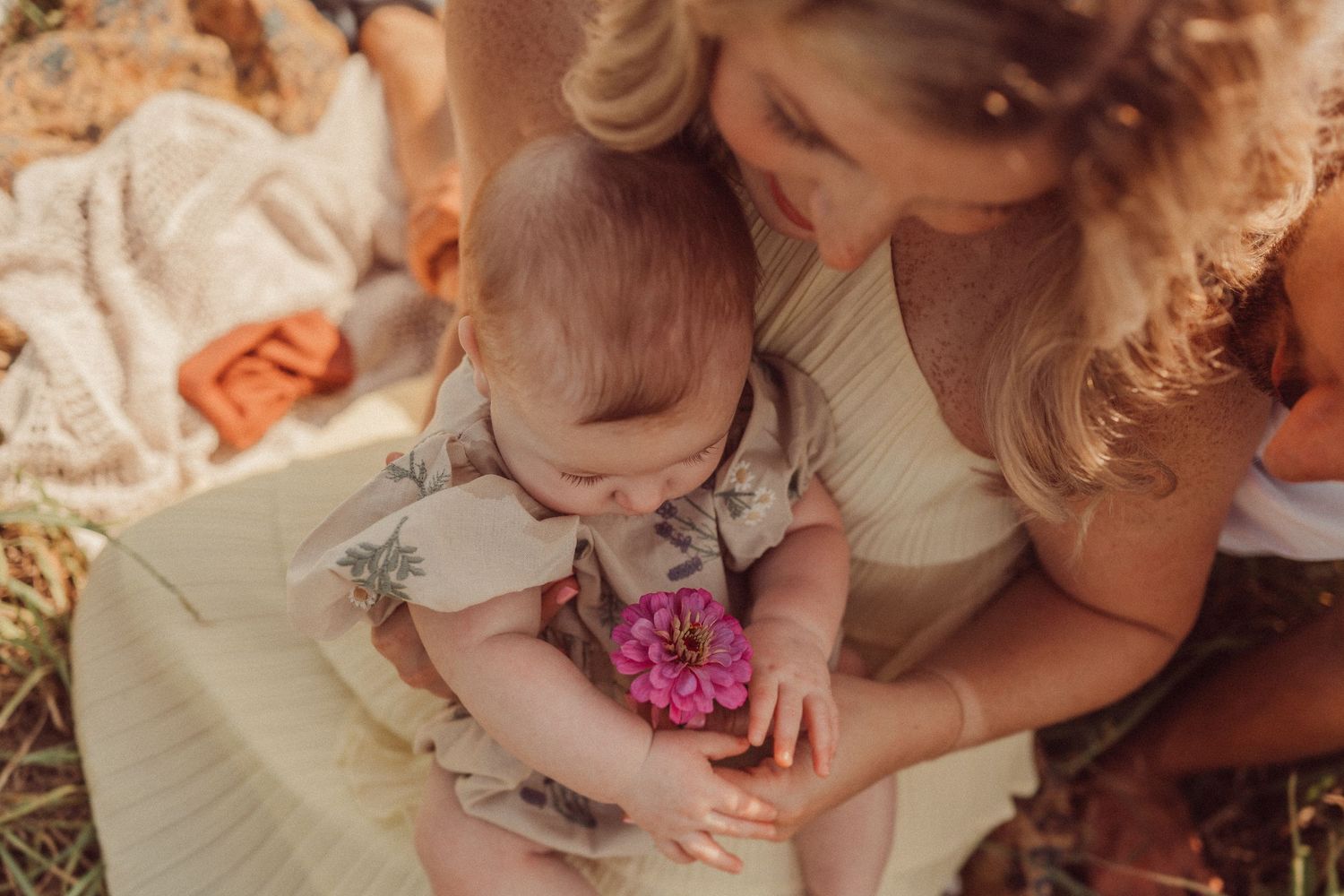 An intimate moment shared while examining flowers in a summer garden.