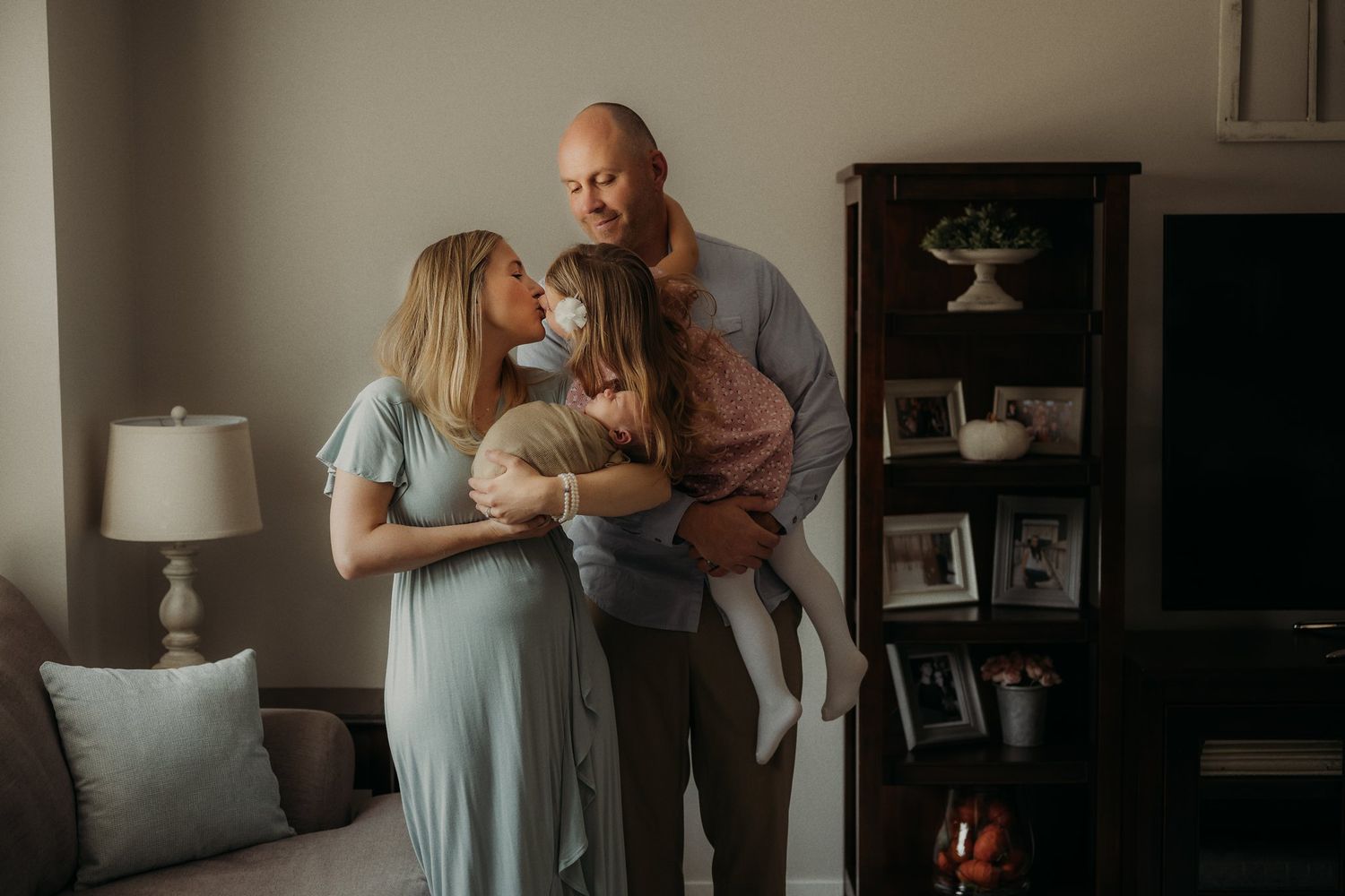 Intimate family moment captured in living room with soft lighting.