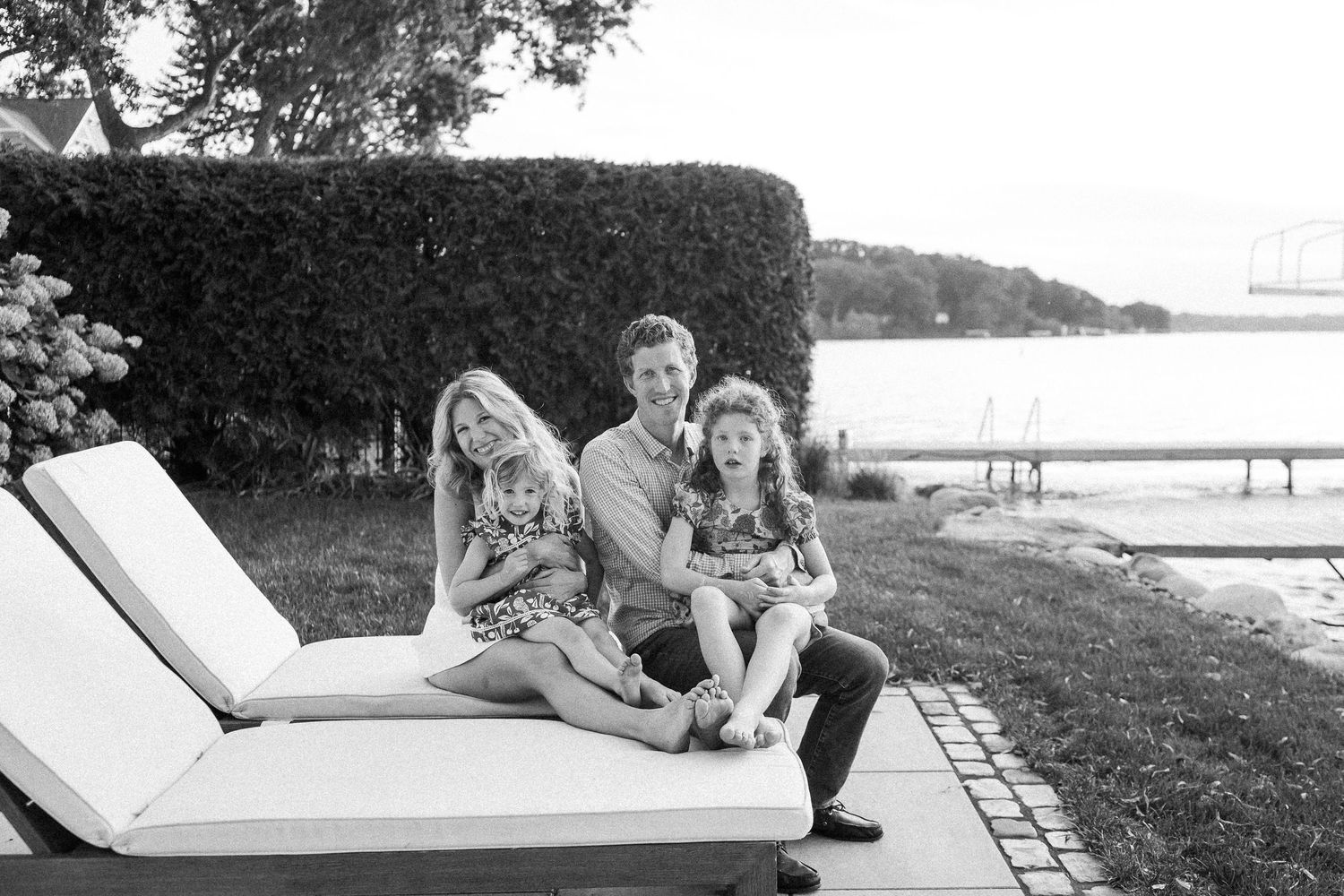 A series of black and white photos showing people relaxing on lounge chairs by a waterfront setting.