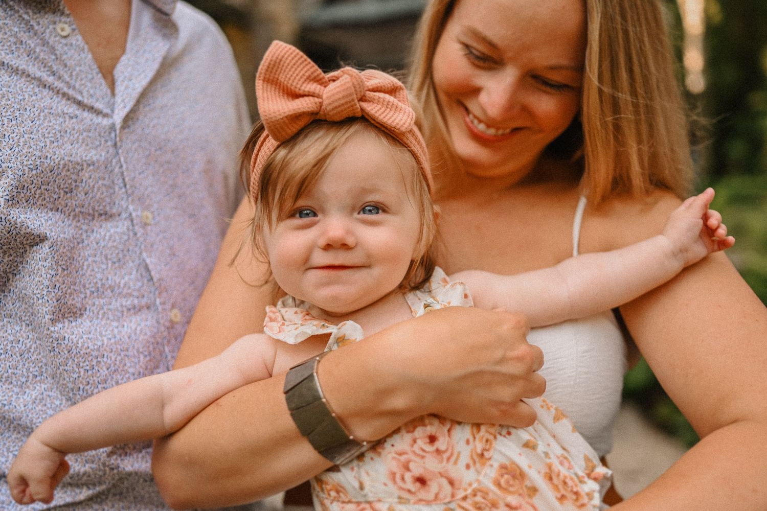 A tender moment captured between three people during an outdoor photo session.