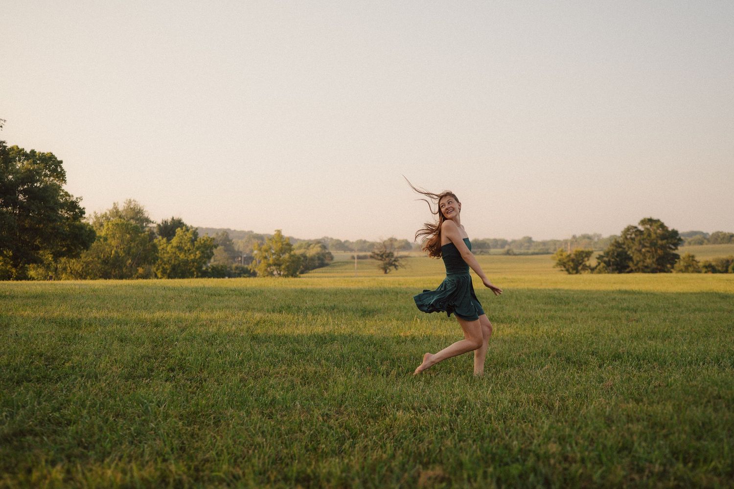 Dynamic dance poses captured in a golden field during sunset with dramatic lighting.